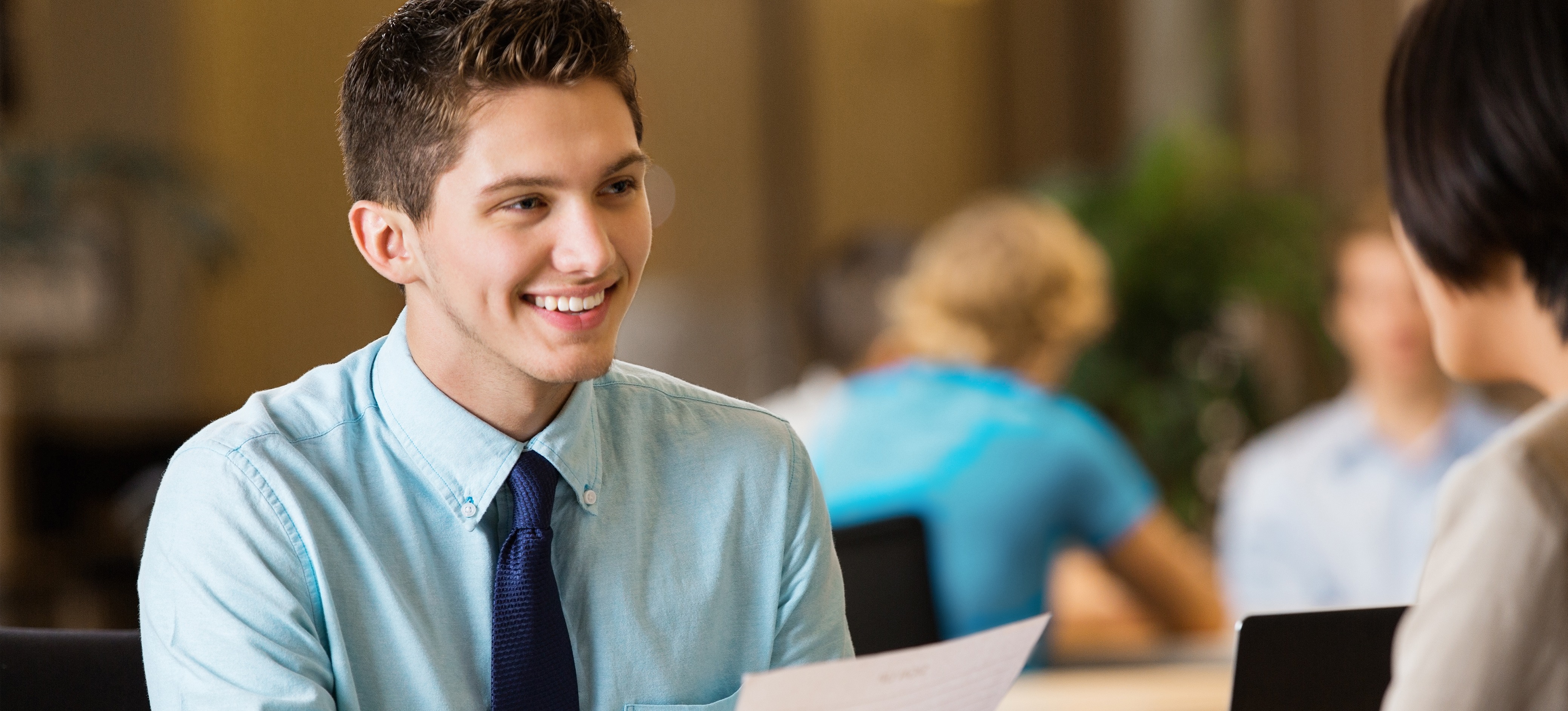 [Featured image] A young person shows their resume with no experience to a hiring manager.