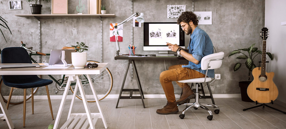 [Featured Image] A designer takes a short break from using graphic design tools while working on their latest project. 
