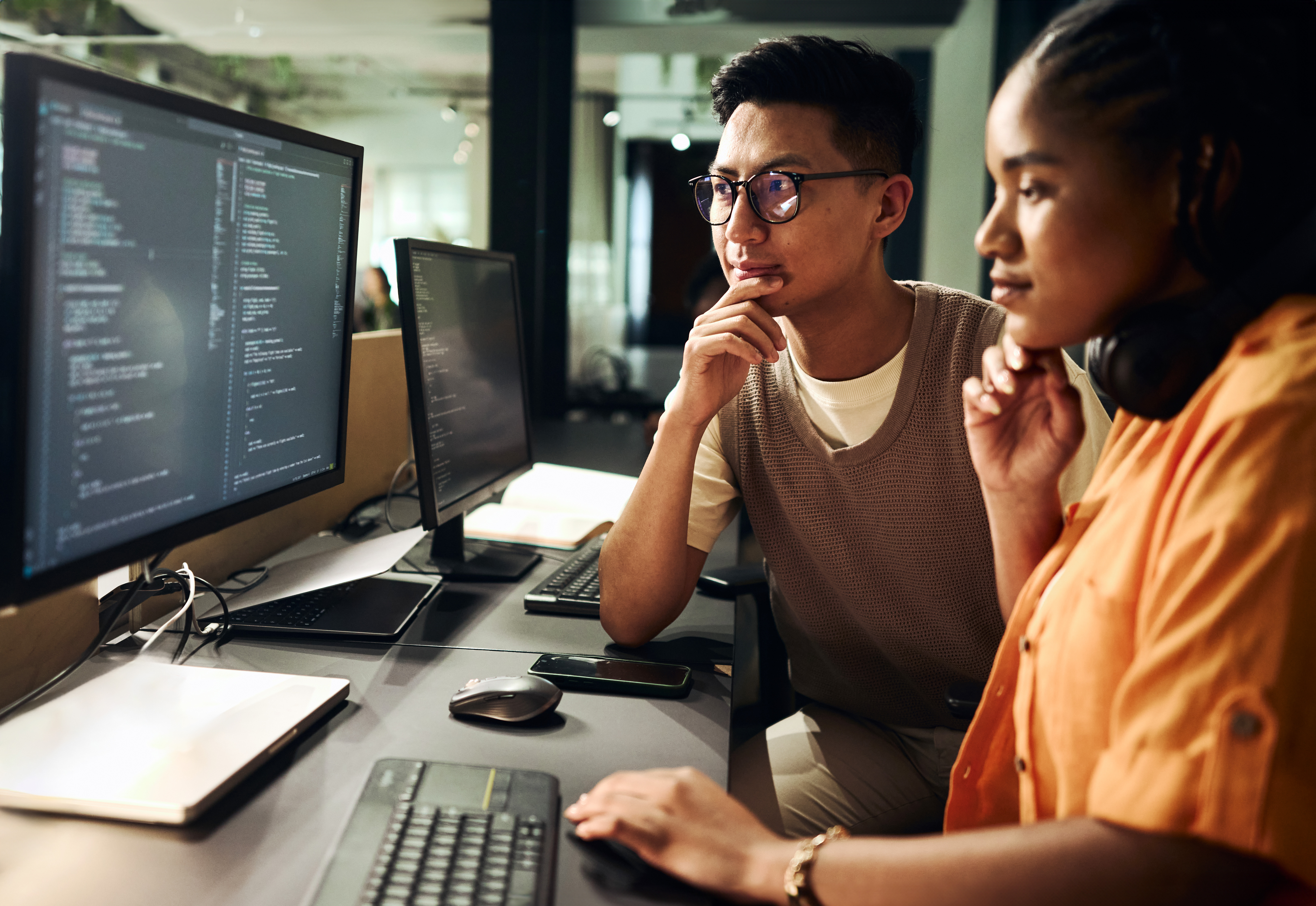 [Featured Image] A cryptographer who works at NIST uses quantum-safe encryption encryption while working at a computer with two monitors.