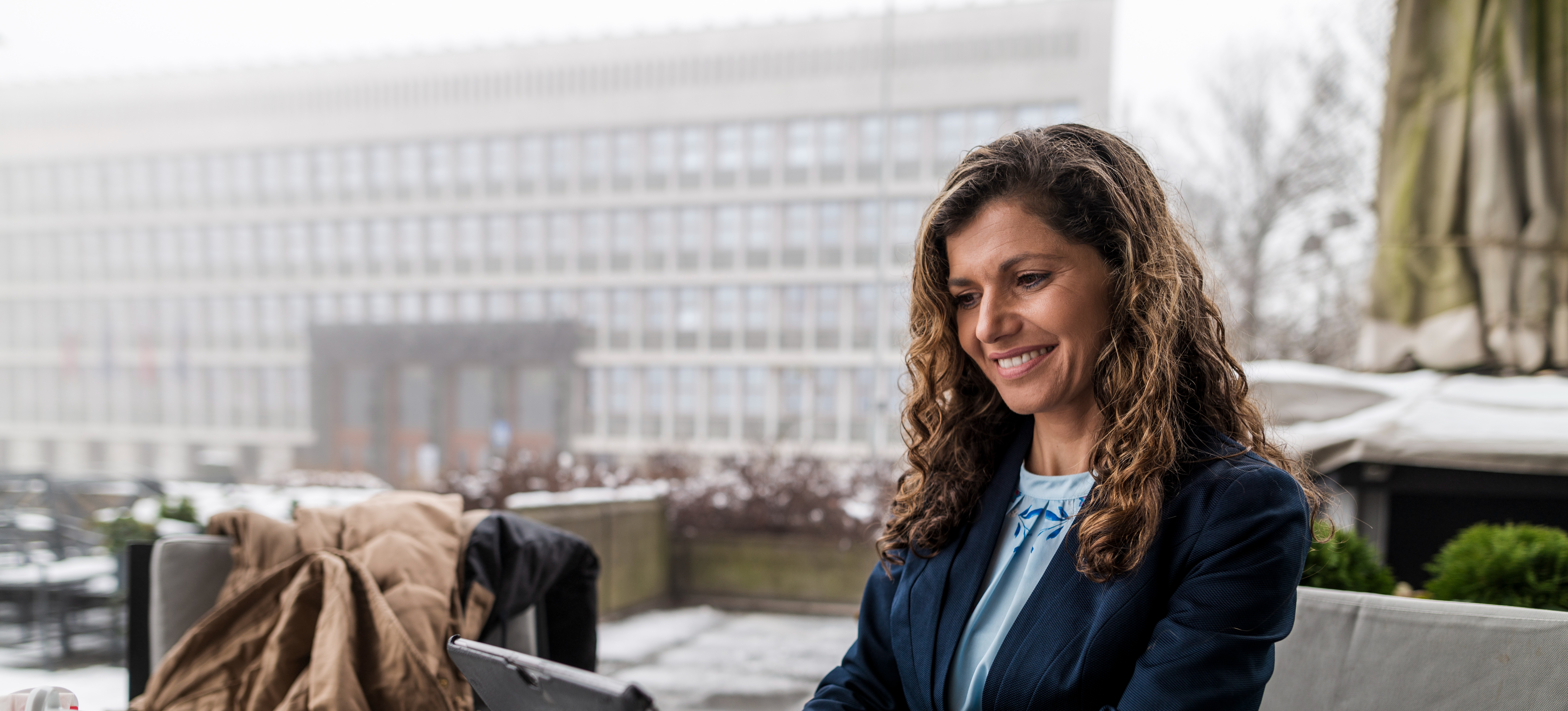 [Featured image] An office manager is sitting at their desk working on their desktop computer. 