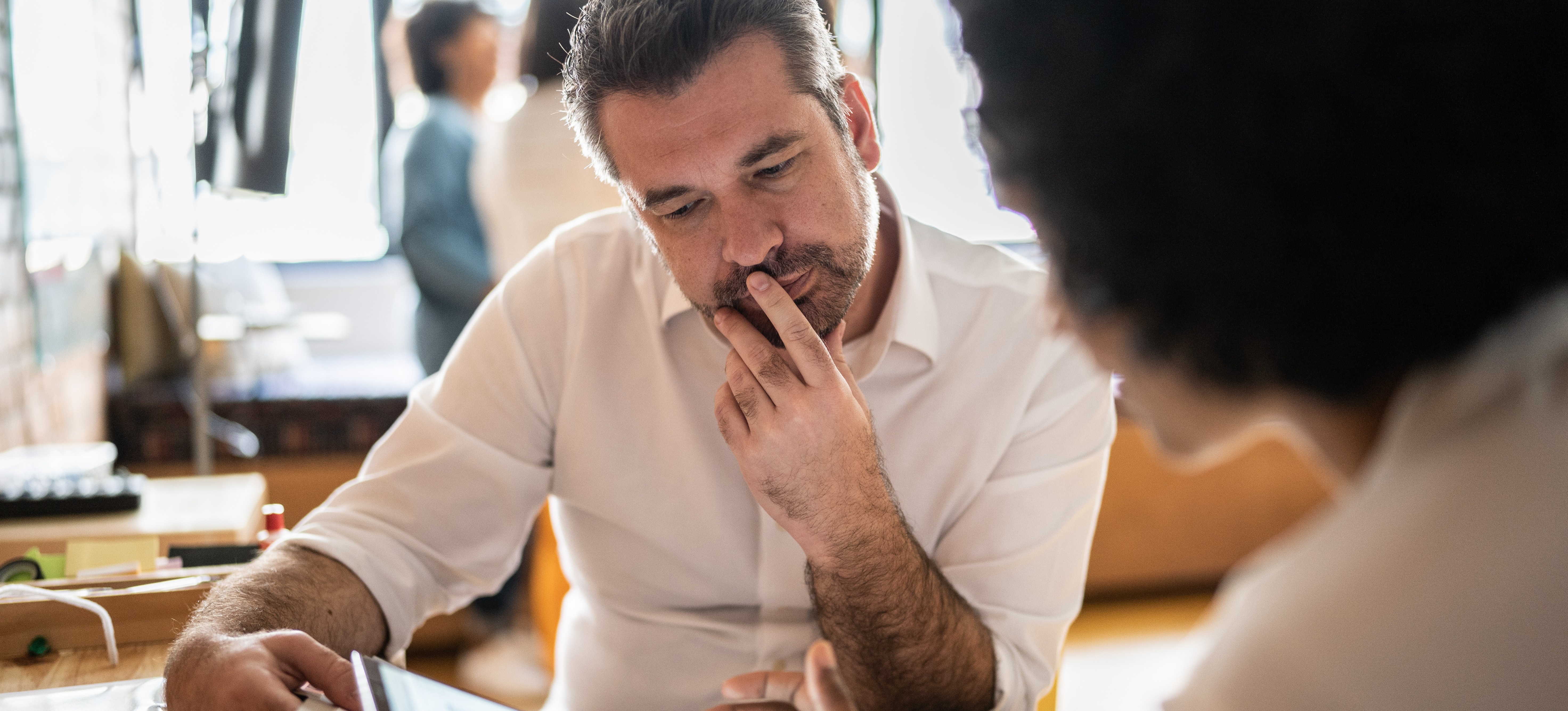 [Featured Image] Two business colleagues are evaluating the human computer interaction on their website.