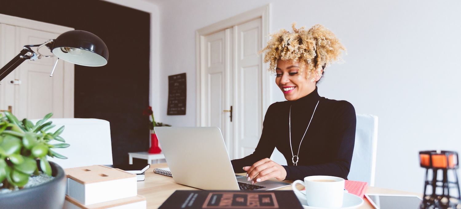 [Featured image] A young product marketing manager sits at her desk and looks over a new marketing campaign on her laptop.