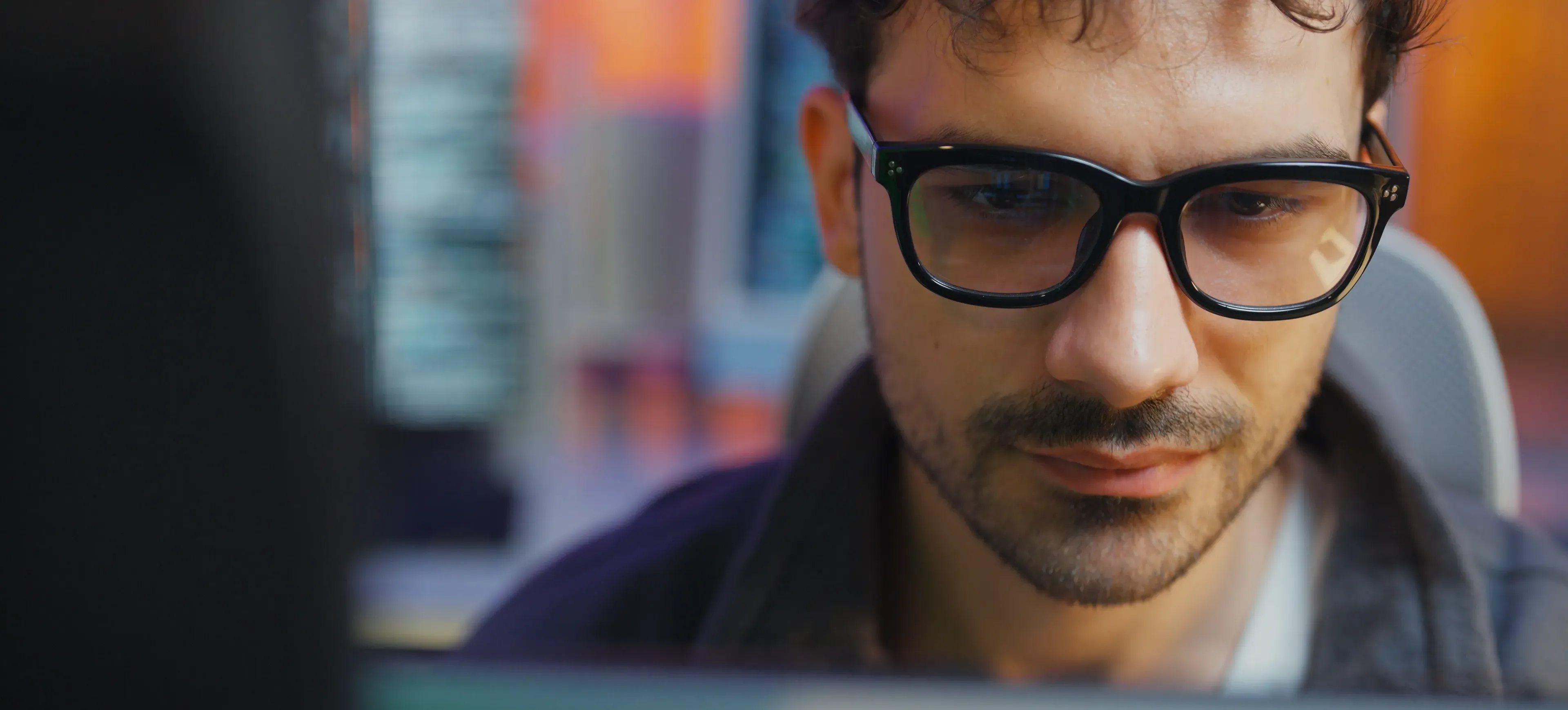 [Featured Image] A software developer works at a computer, using Docker Compose to streamline their development.
