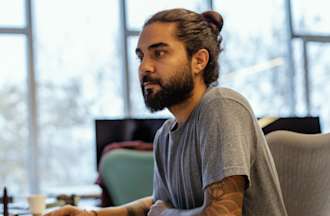 [Featured image] Man at computer working on organizing data