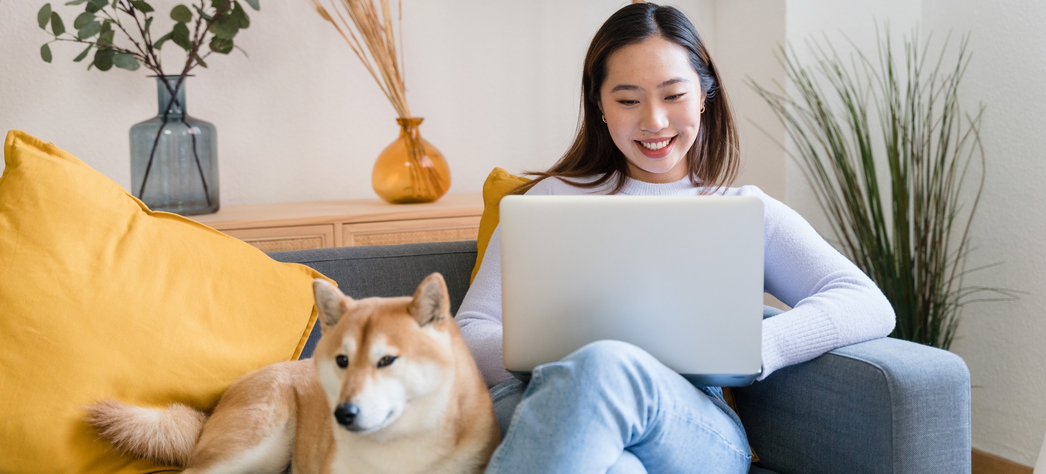 [Featured Image] A learner works on their laptop beside their dog while studying binary classification.