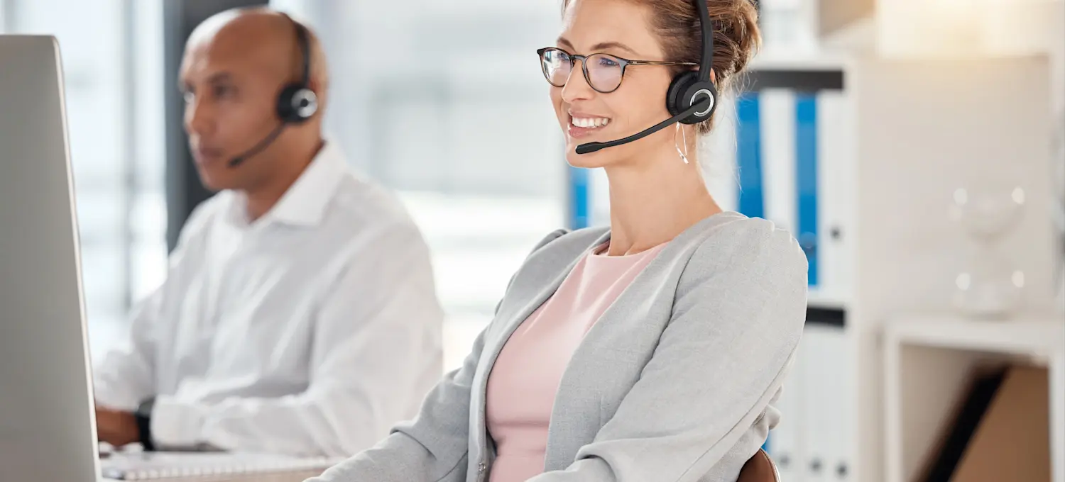 [Featured Image] A public safety dispatcher, one of many civilian DOD jobs, uses a laptop and headset to take a call. 
