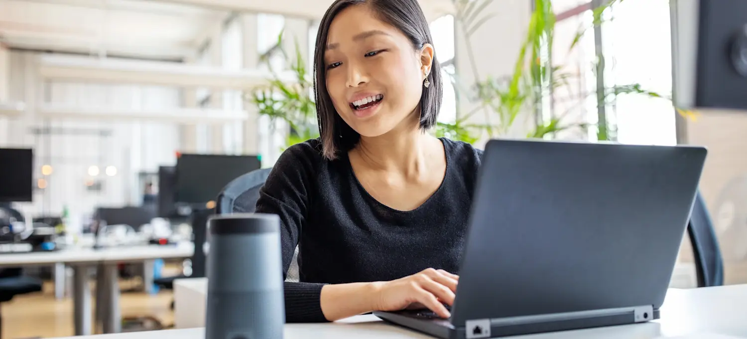 [Featured image] An accountant works at their laptop computer in a brightly lit office.