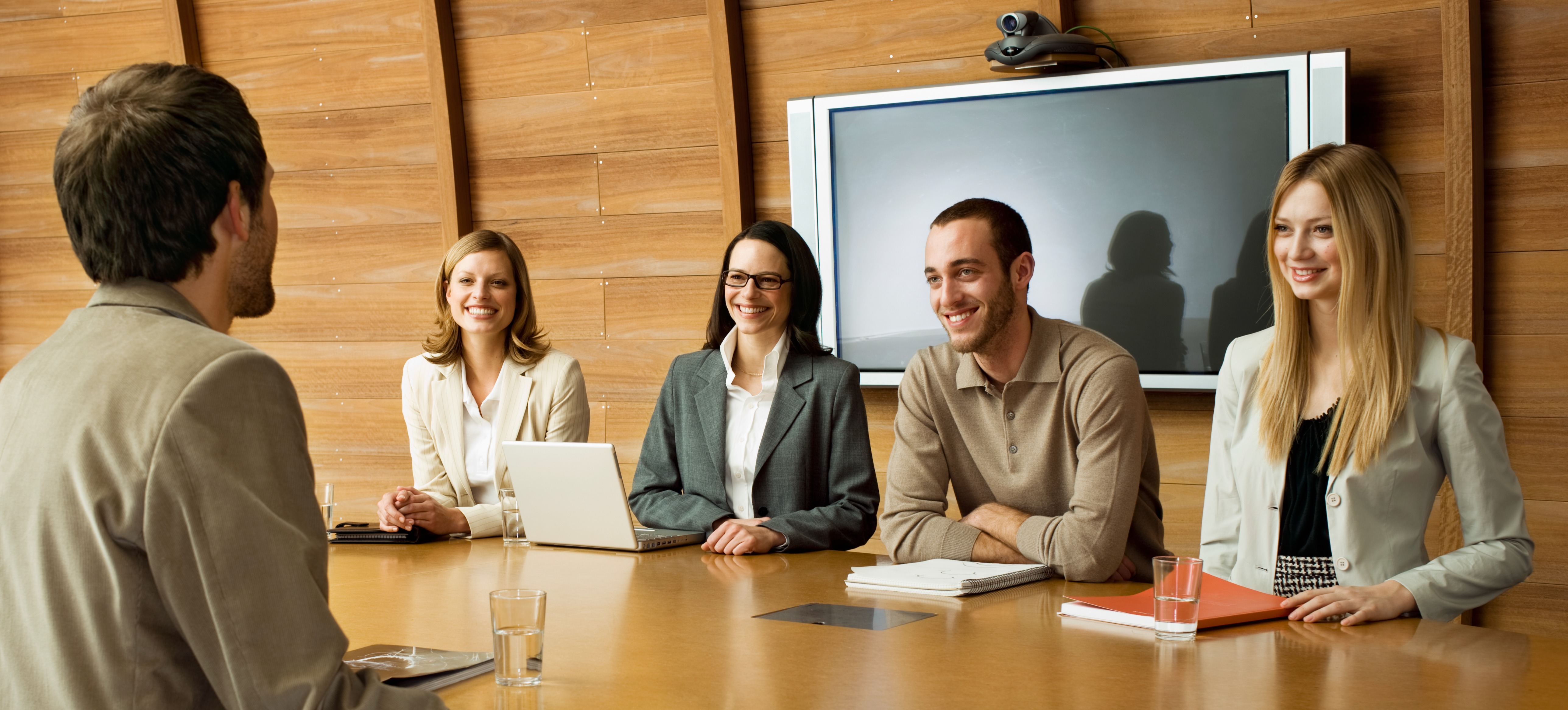 [Featured Image] A group of professionals in a workplace environment conducting a job interview with a candidate, asking TensorFlow interview questions.
