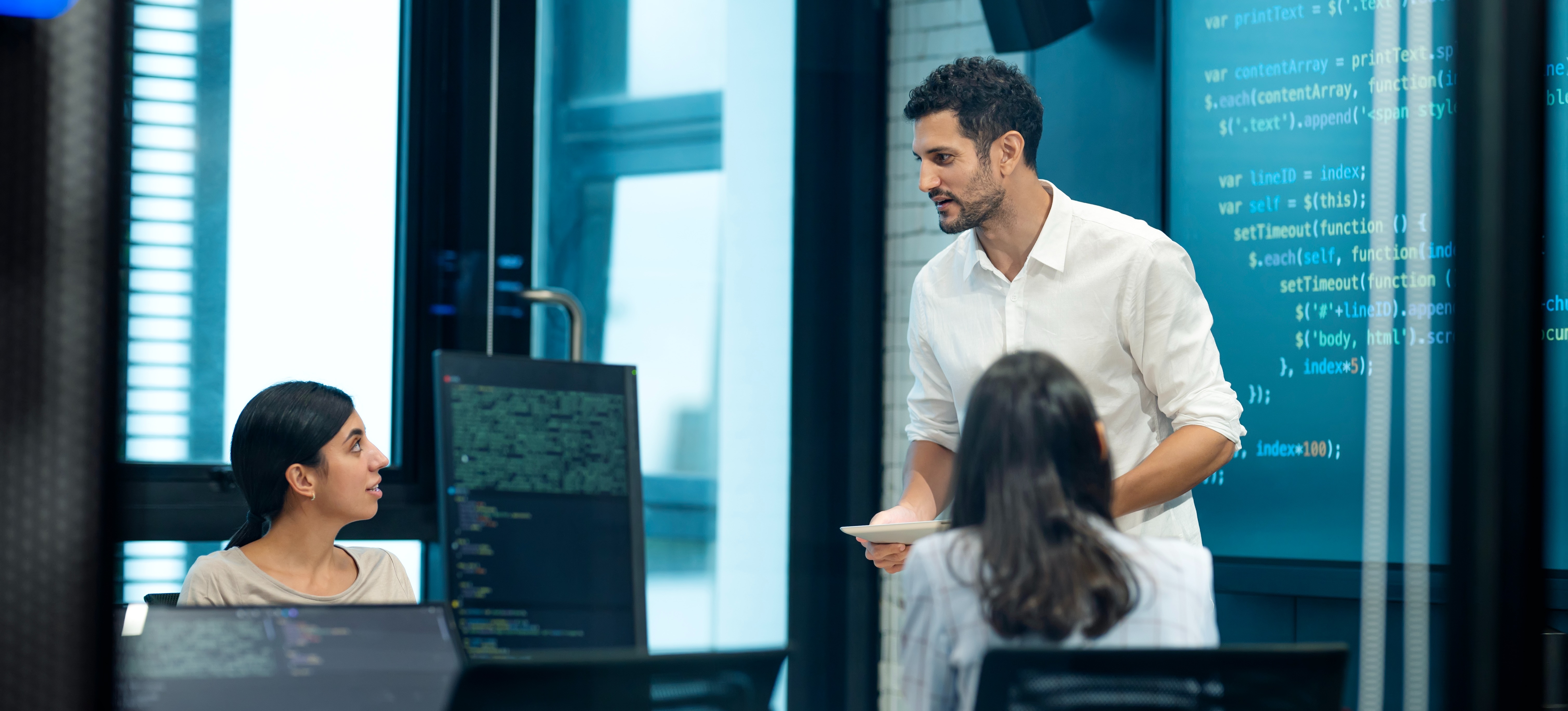 [Featured Image] A team in a meeting at a workplace, discussing the best data privacy certification.