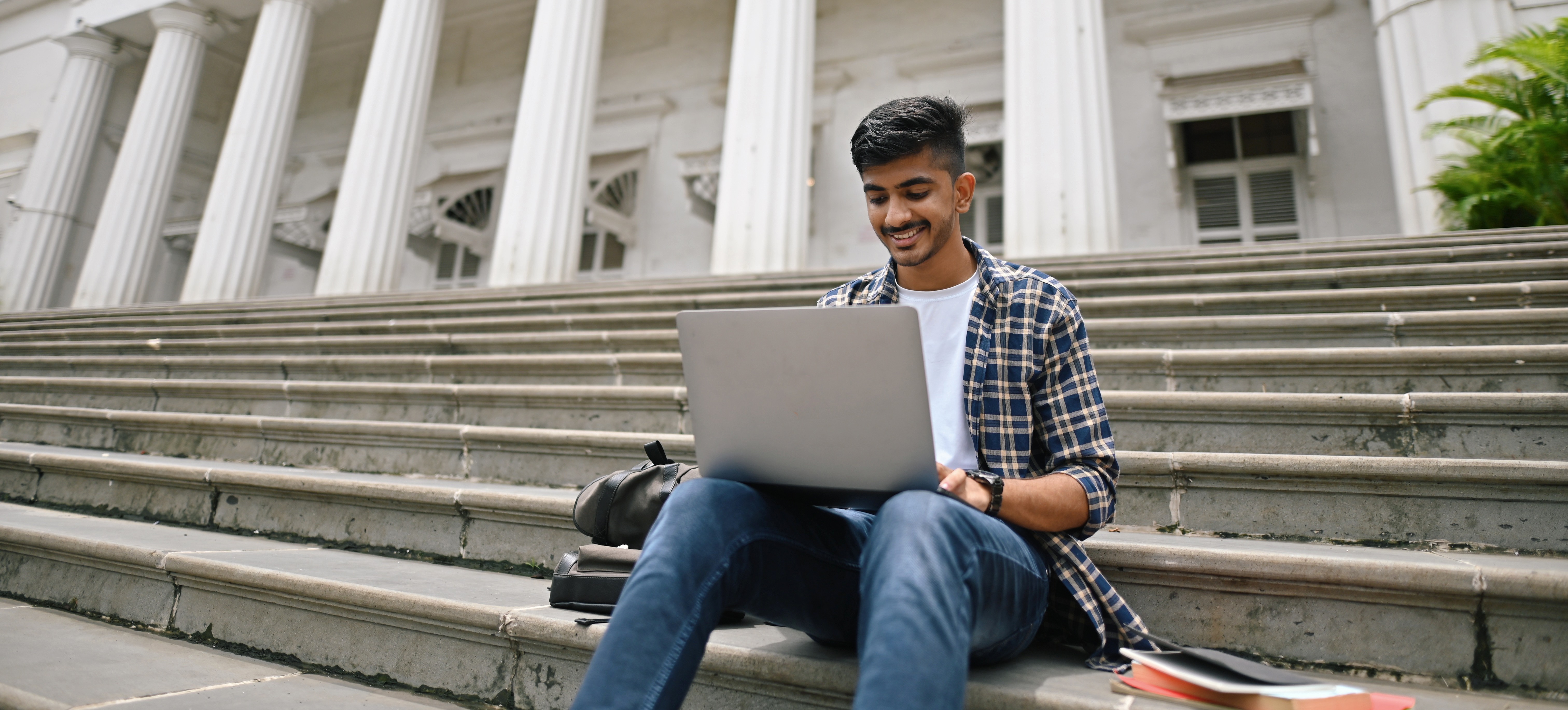 [Featured Image] A college student is relieved after passing a BBA entrance exam that allows him to apply for the program.