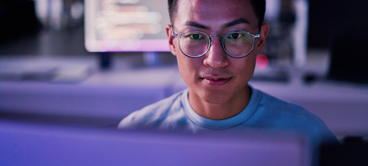 [Featured Image] A cybersecurity professional working on his desktop with IDS and IPS to secure his company's networks.