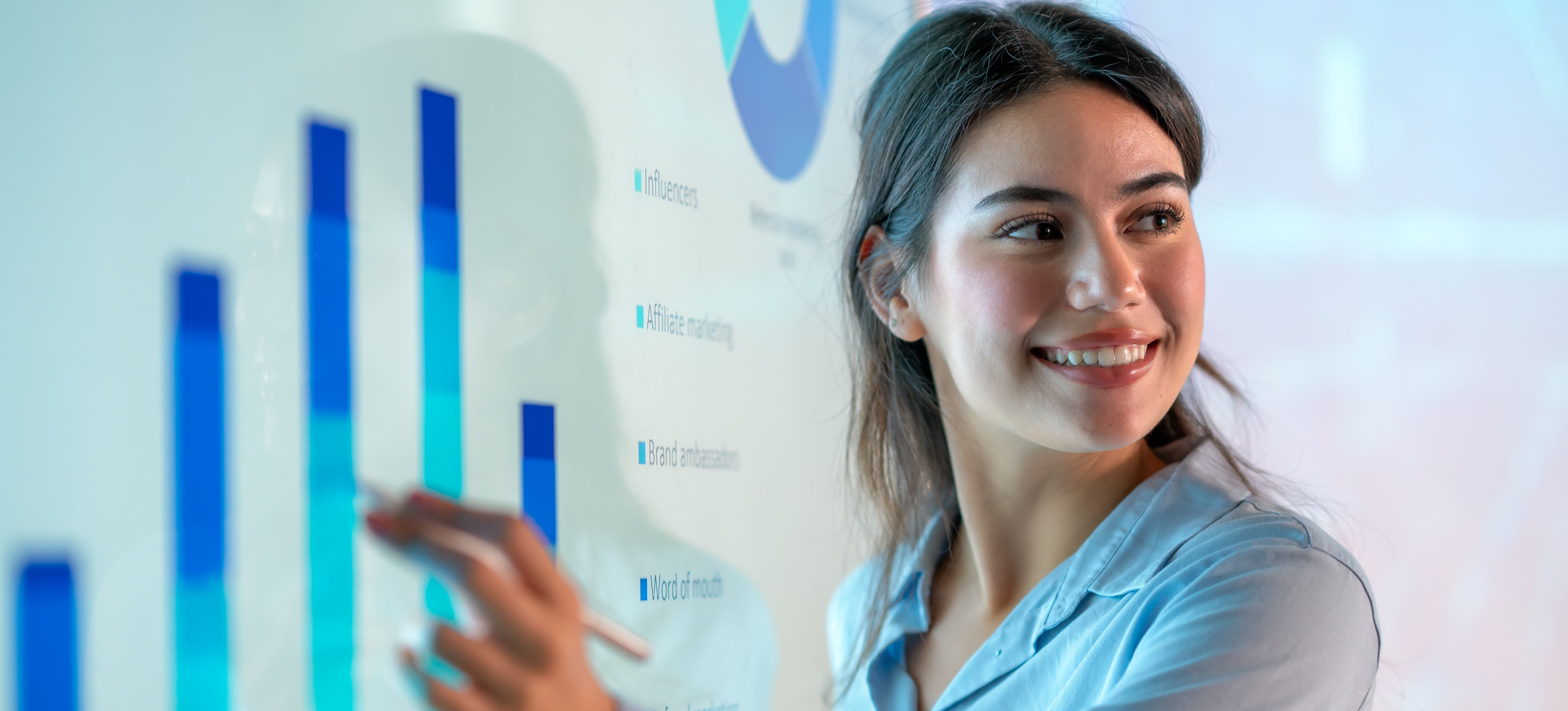 [Featured Image] A professional reviews customer analysis graphs during a meeting in a professional workspace.
