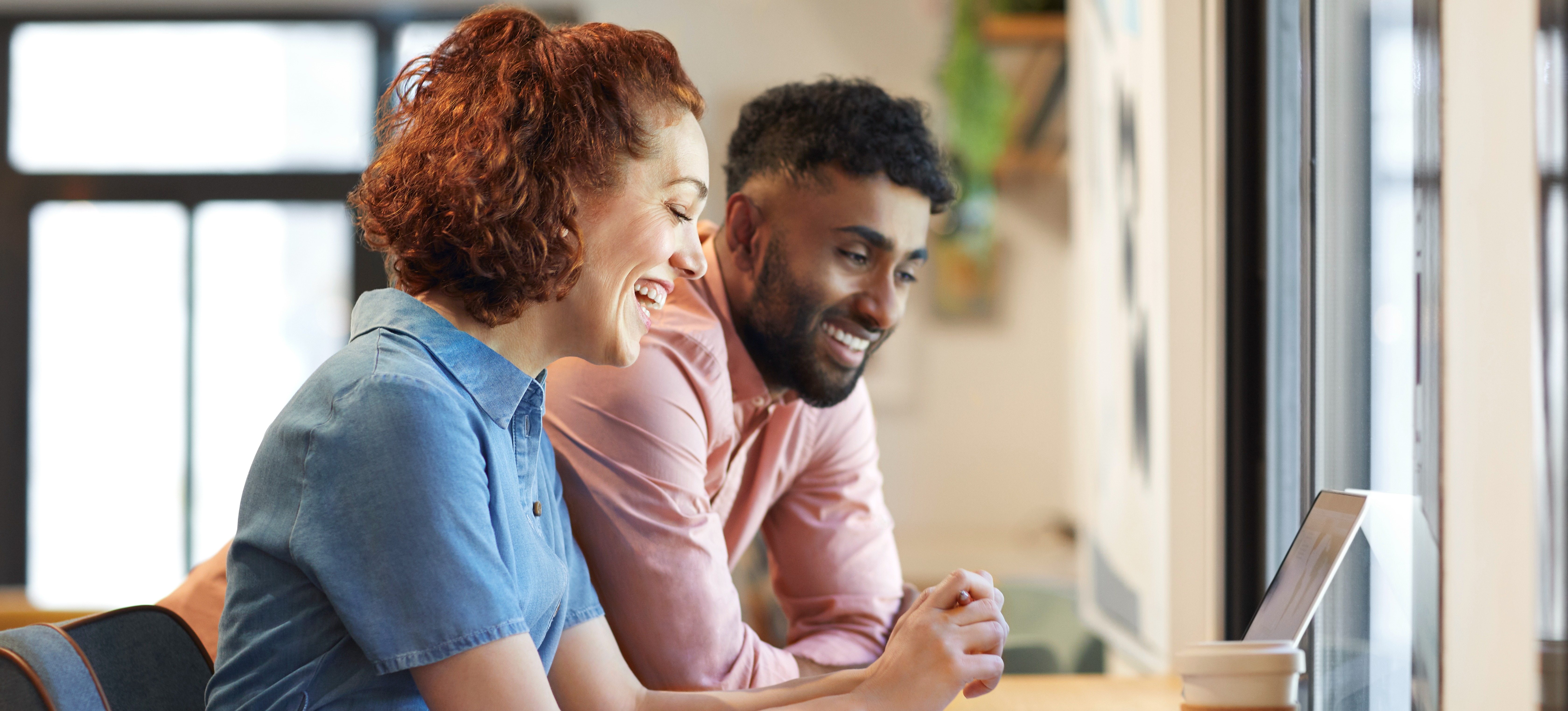 [Featured Image] Two learners research how to become a penetration tester on a laptop.
