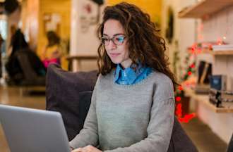 Girl looking up IT certifications in cafe