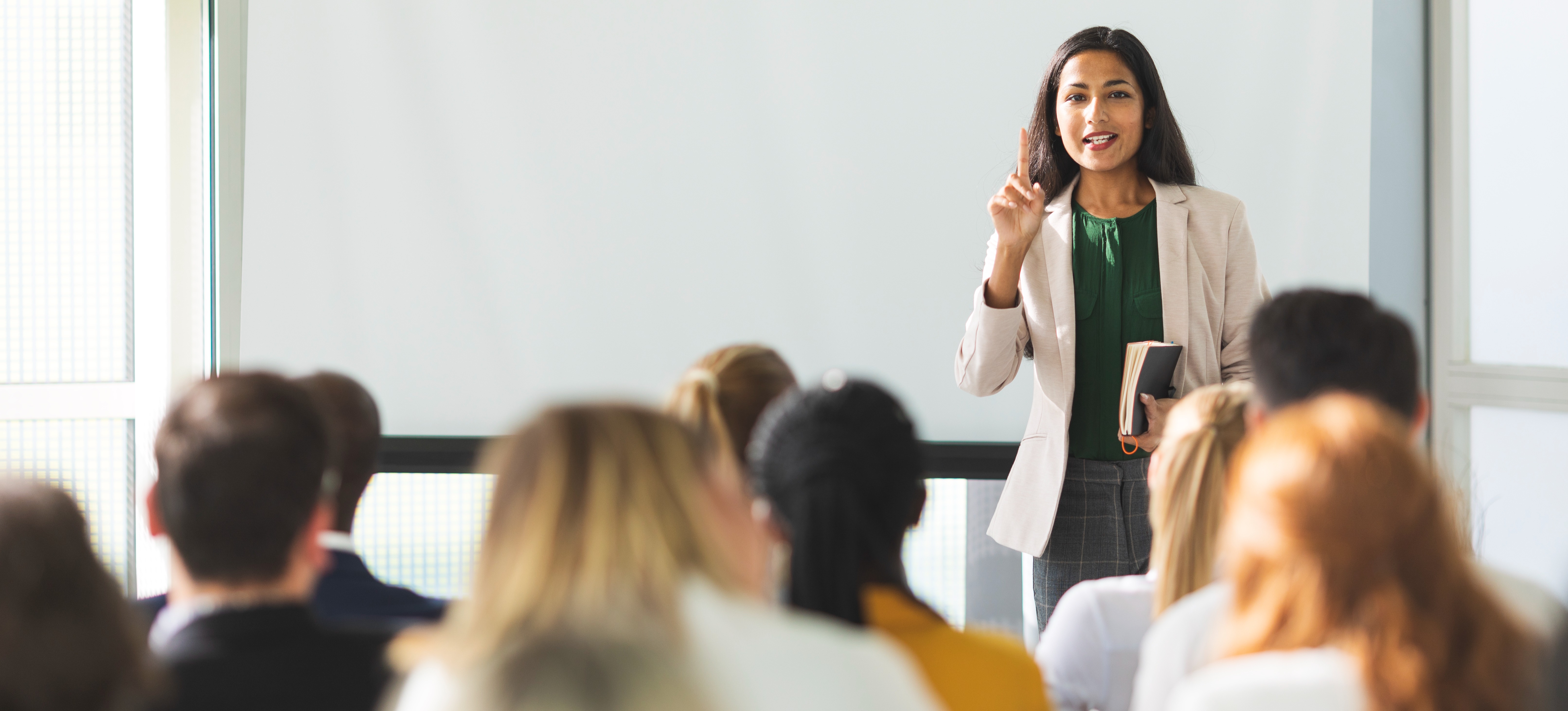 [Featured Image] A business leader outlines the organization’s disaster recovery plan to its employees. 
