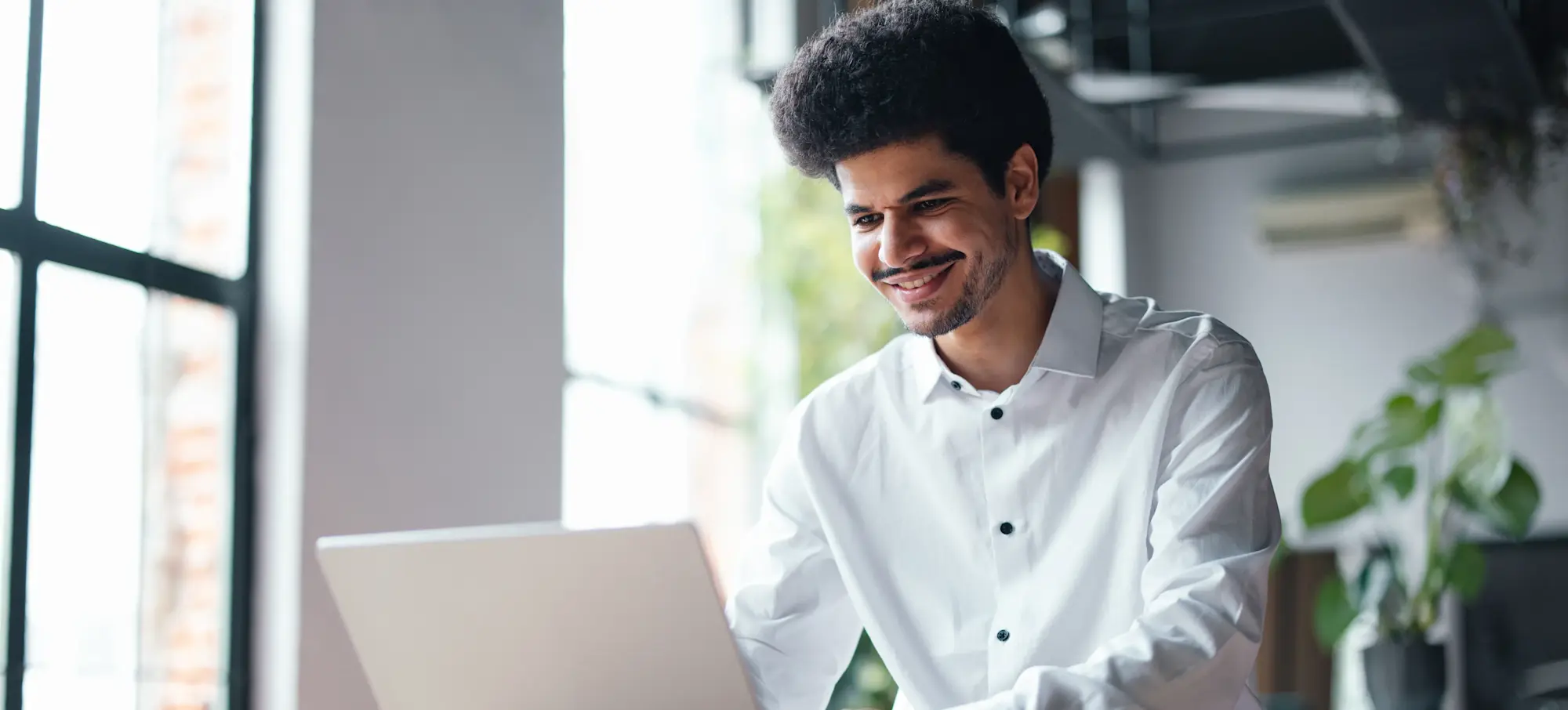 [Featured image] A machine learning engineer designs machine learning systems at their desk.  