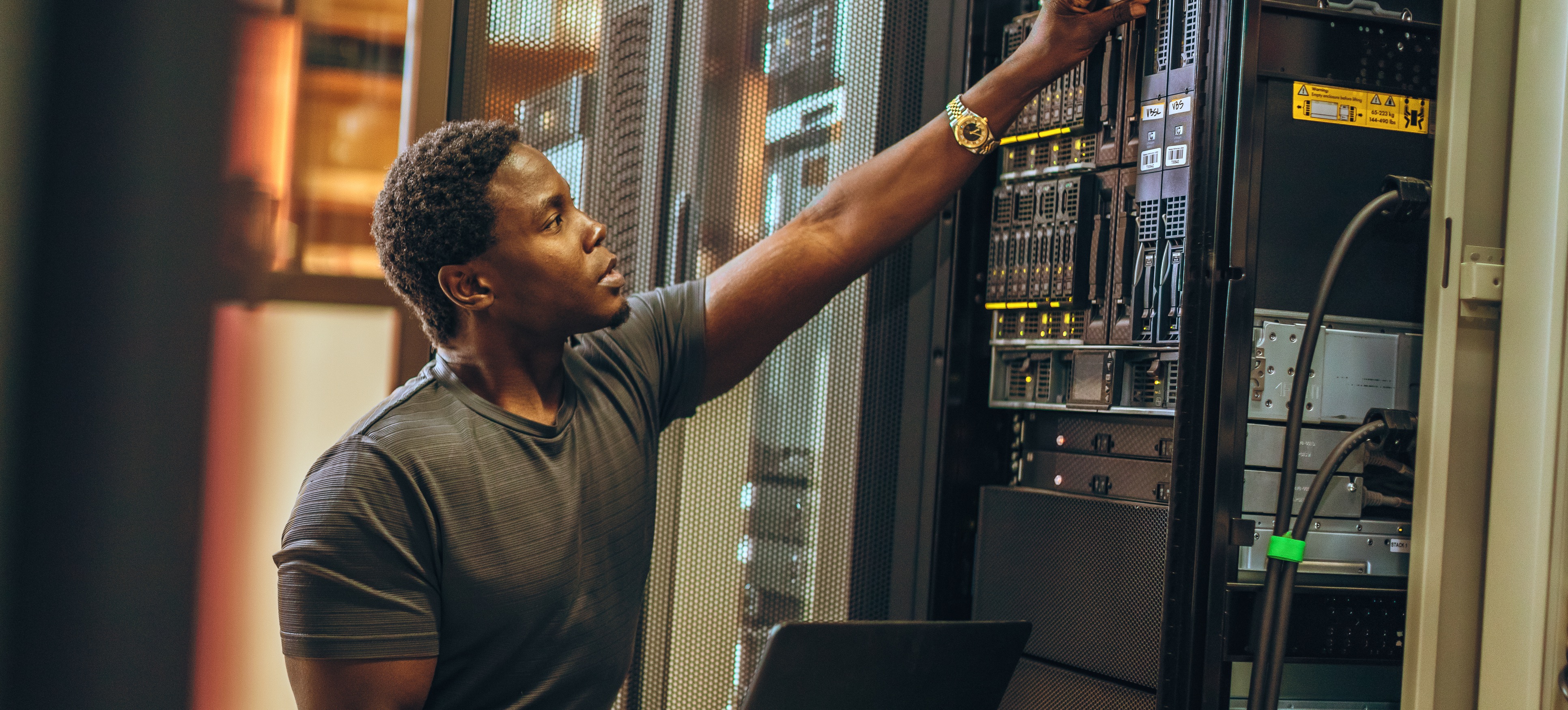 [Featured image] A security engineer is doing maintenance on a company's physical server machines.