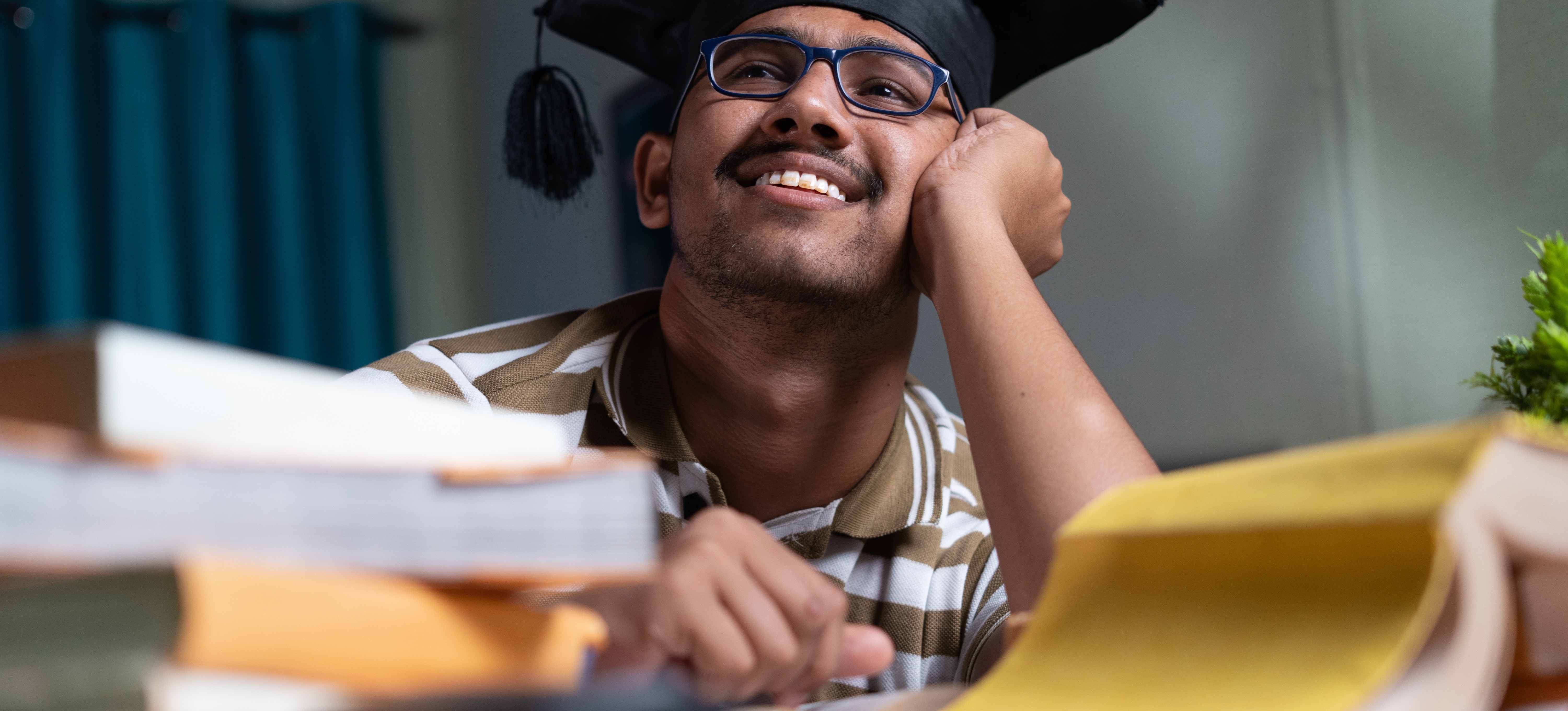 [Featured Image]: A young person wearing a graduation cap thinks about what they can do with a bachelor of arts degree.
