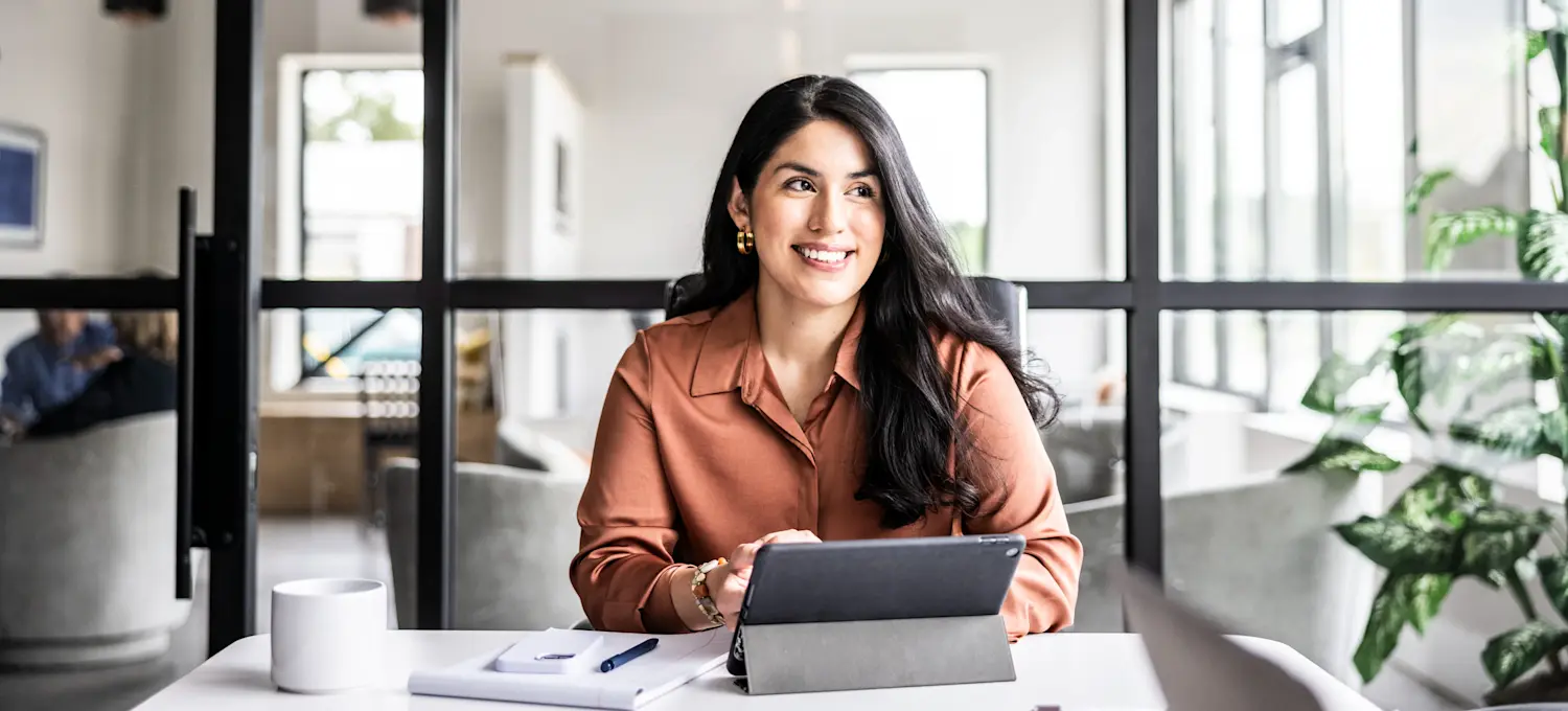 [Feature Image] An aspiring project manager learns how to use Excel and practices on a tablet.
