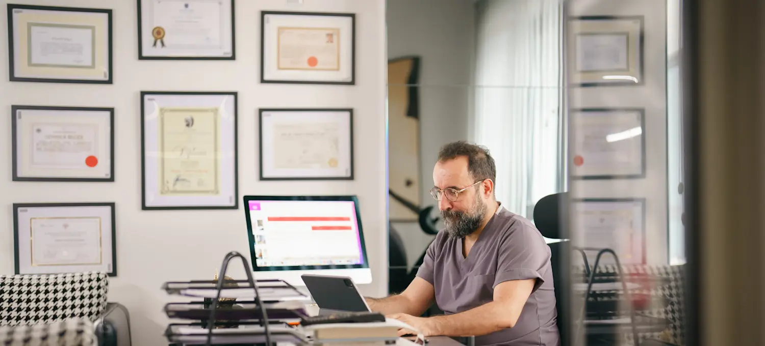 [Featured Image] A person in their home office is on their laptop, working on getting a computer science certification.