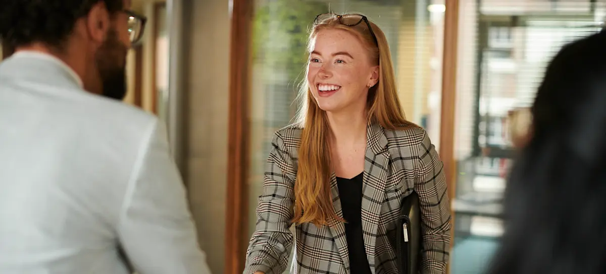 [Featured image] A data architect is being introduced to an employer for a job interview.
