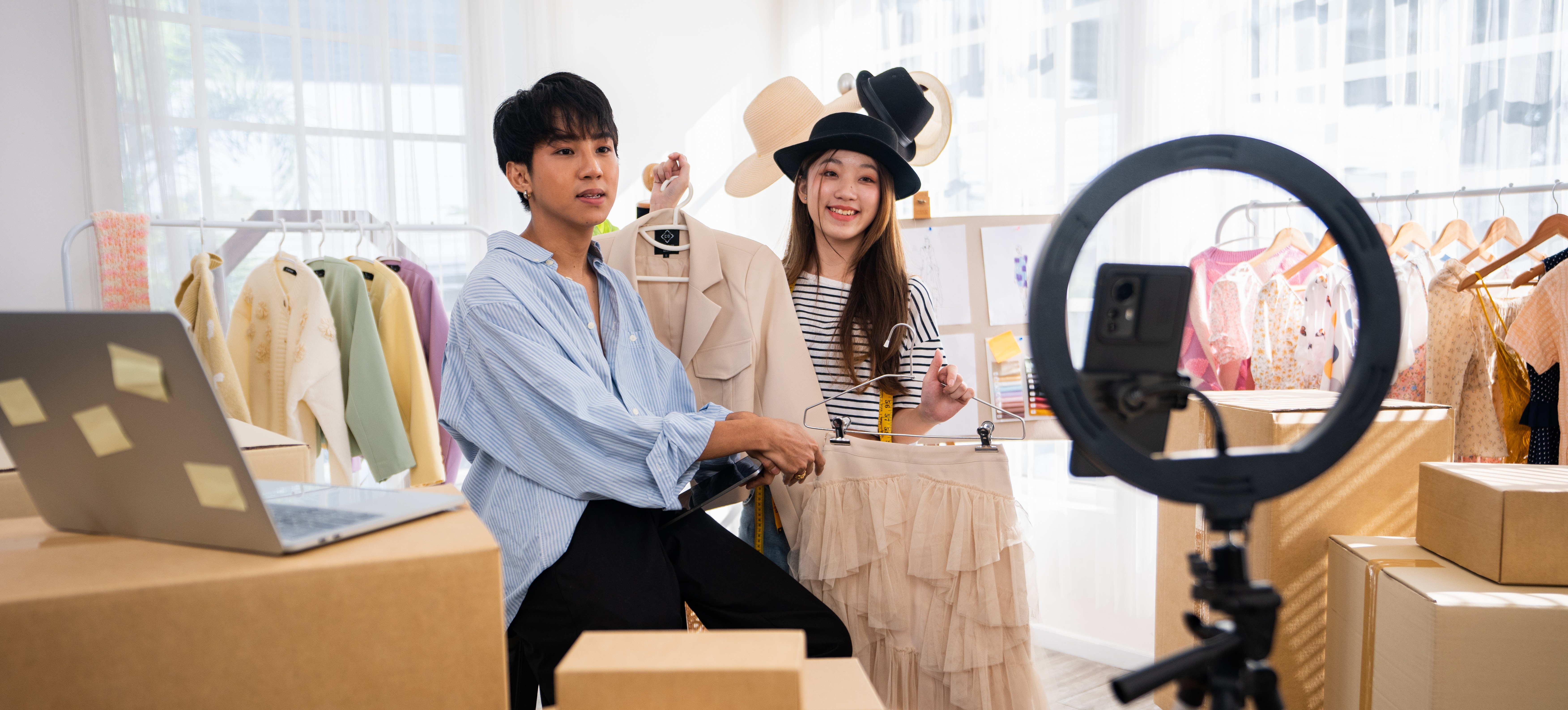 [Featured image]: Two people photographing clothing as part of their digital marketing campaign.
