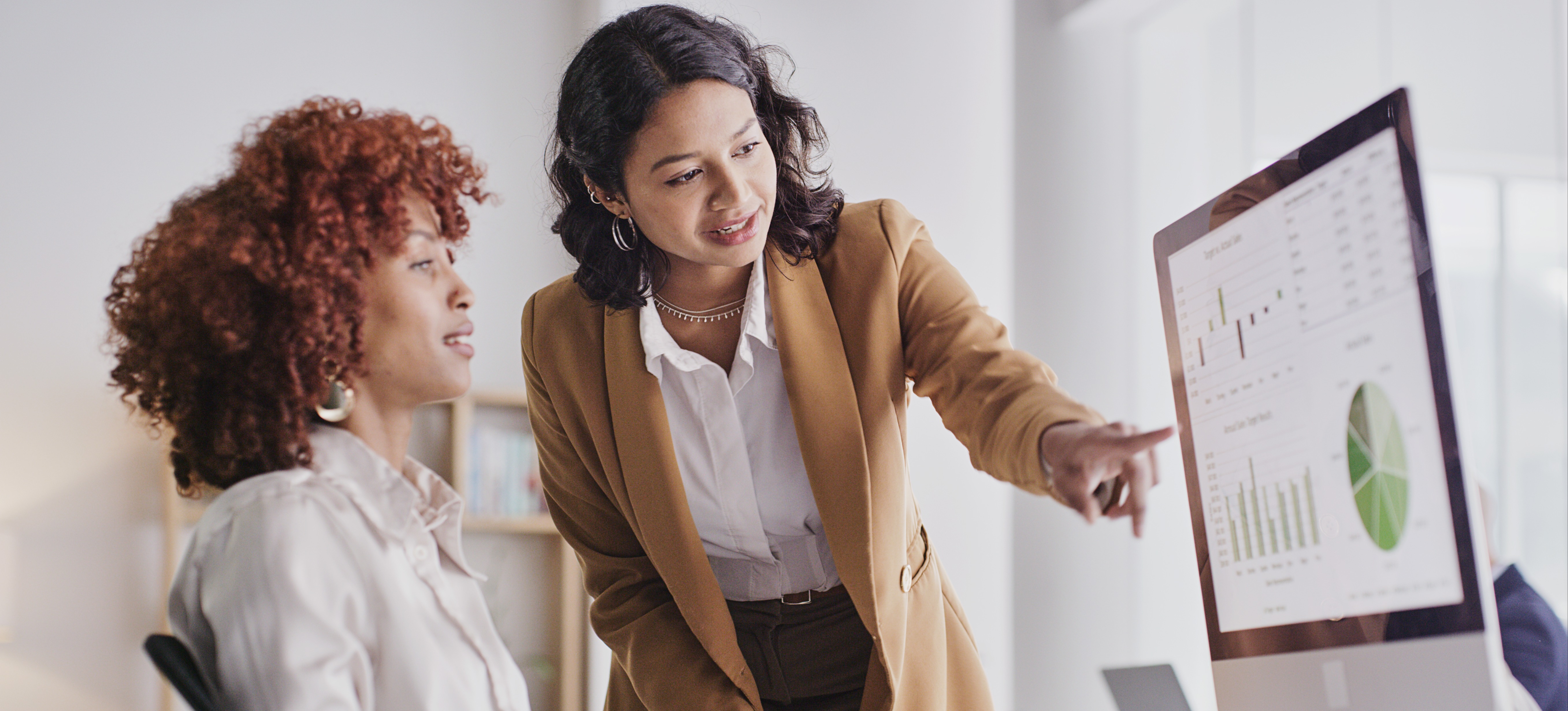 [Featured Image] Two CBAPs evaluate organizational data to present to key company stakeholders.