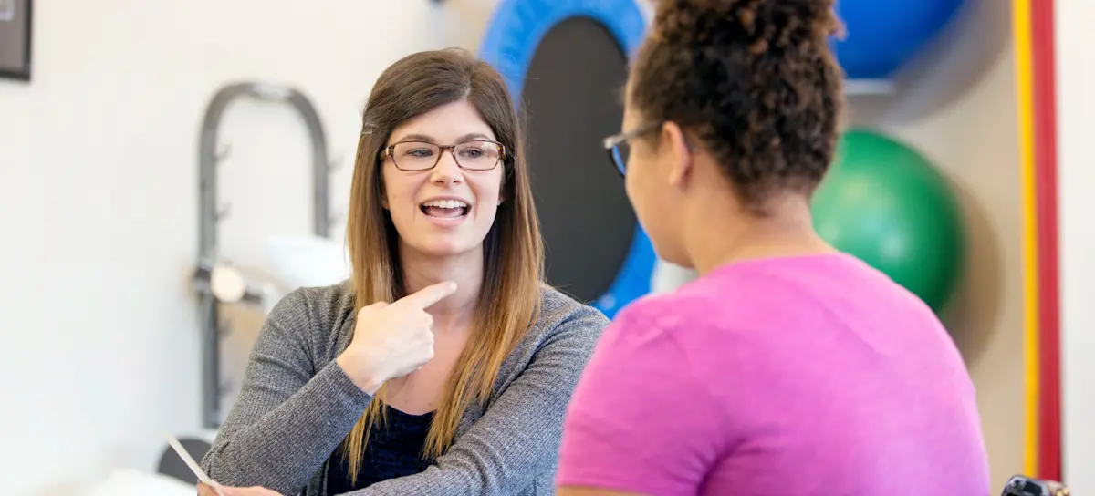 [Featured image] A speech language pathologist works with a patient in a clinic.
