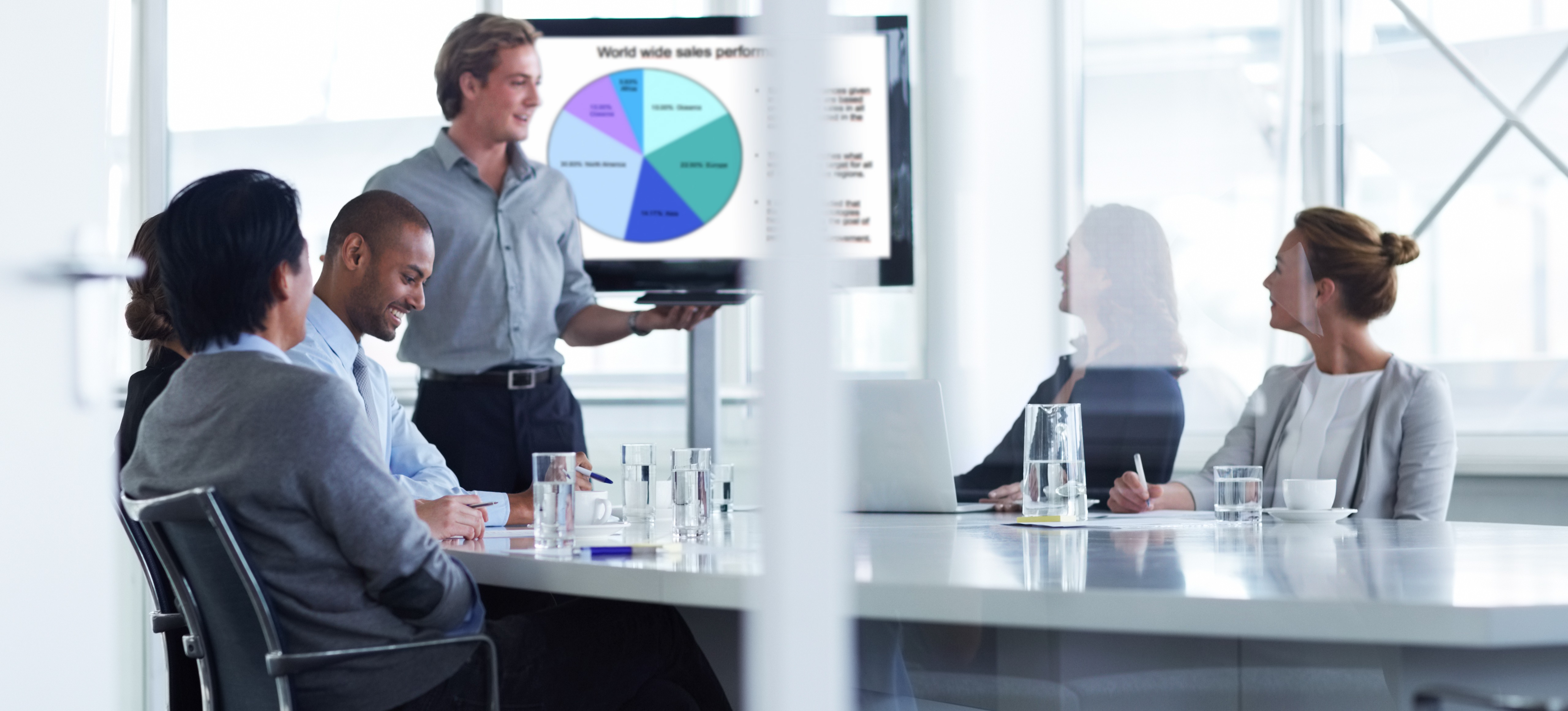 [Featured image] A sales management professional gives a presentation to a sales team.