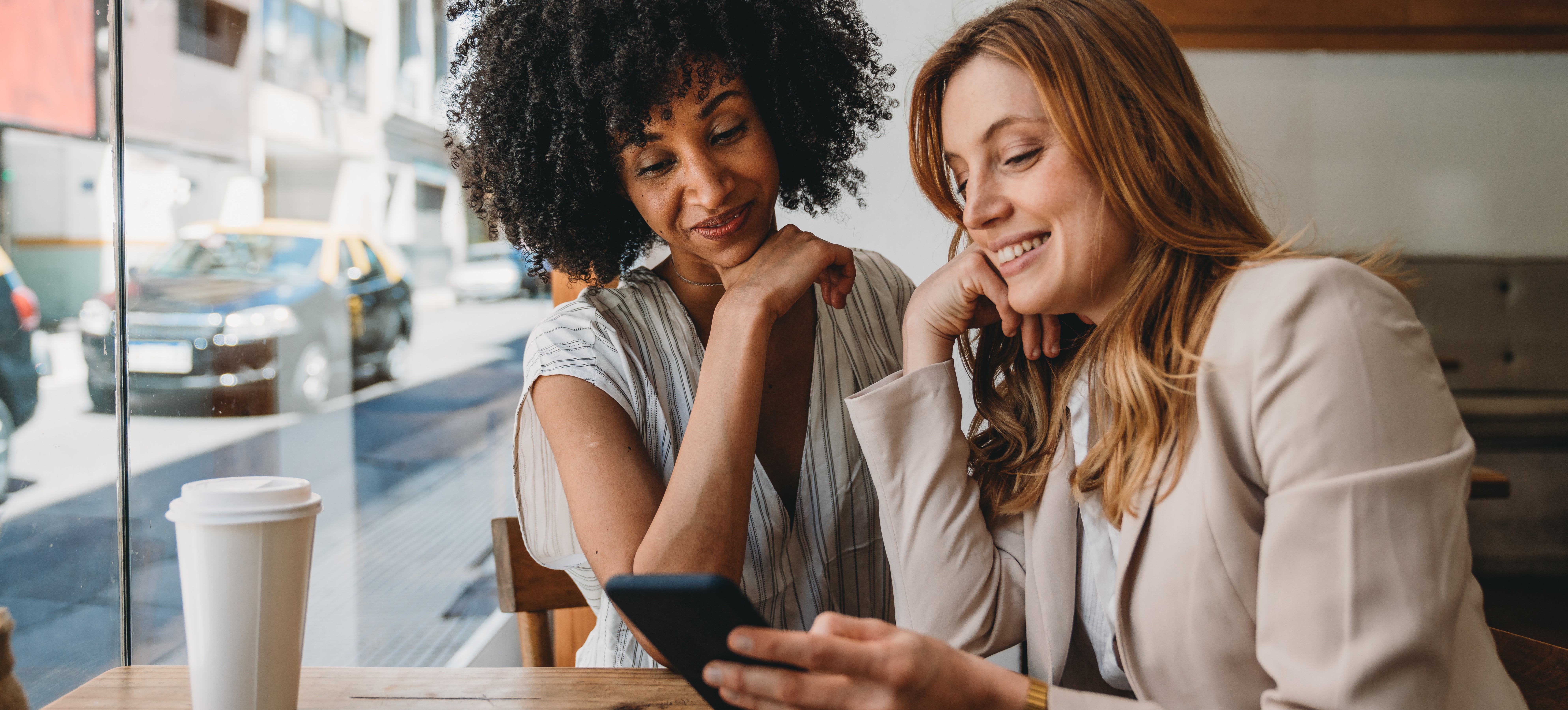 [Featured Image] Two professionals exchange contact information after meeting at a networking event designed to help everyone increase their social capital. 
