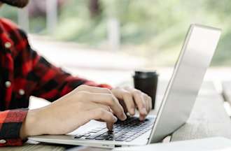 [Featured image] A data scientist works on his laptop outside using the Python library NumPy.
