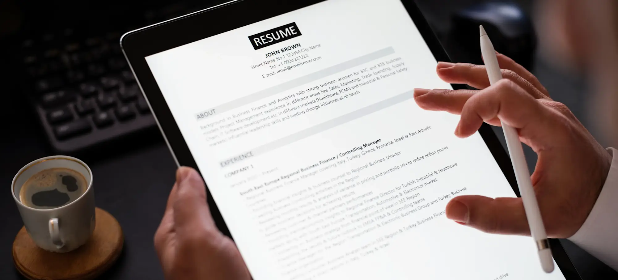 [Featured Image] A person's hands hold a tablet and build a resume through AI.
