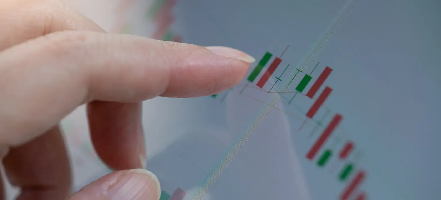[Featured Image] A finger points to a graph showing the analytics of a Shopify store activity.