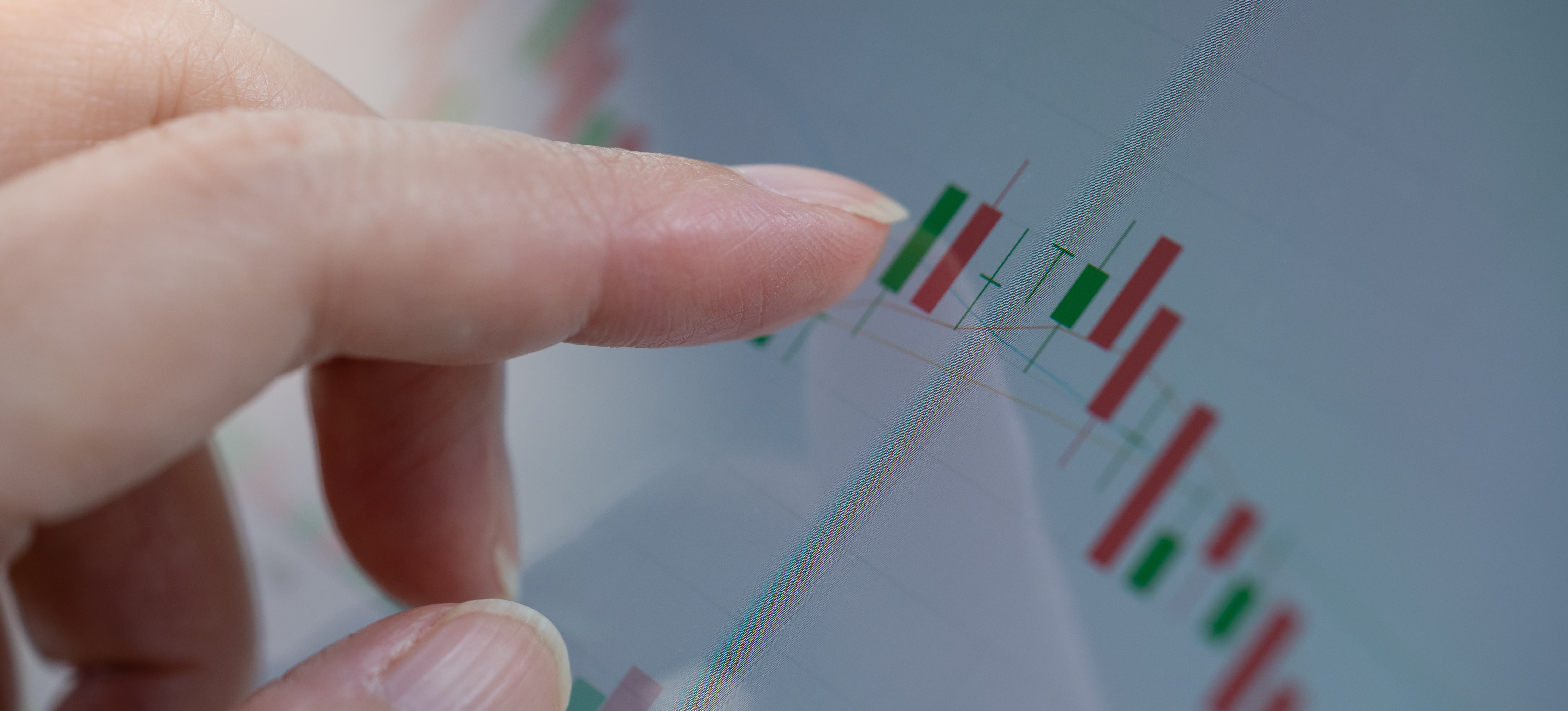 [Featured Image] A finger points to a graph showing the analytics of a Shopify store activity.