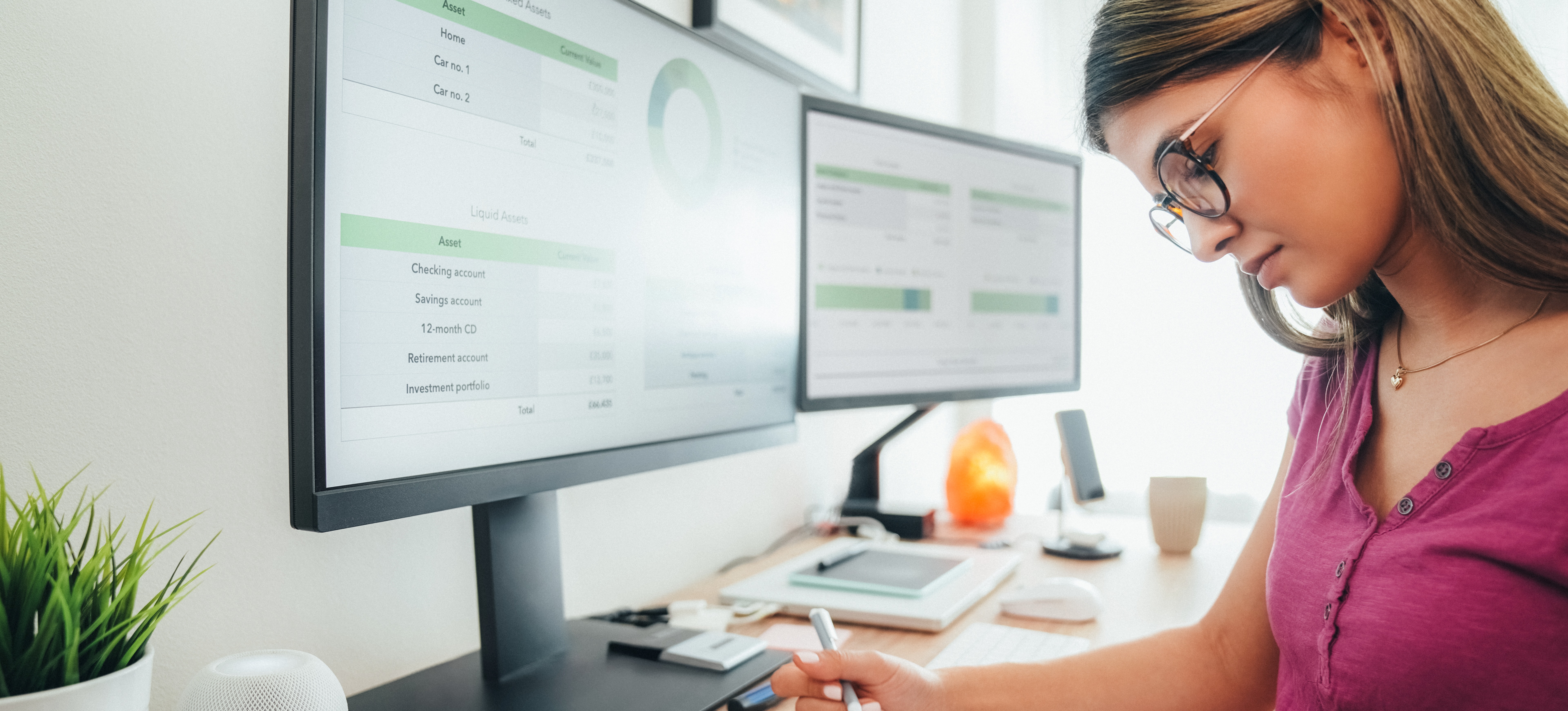 [Featured Image] A woman wearing glasses sits at her computer, filled with budgeting information, and manages her finances as she wonders what a 401k is and how she can get one.
