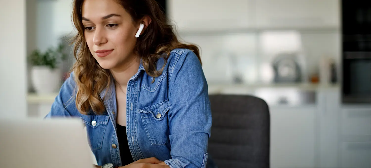 [Featured Image] A person sitting at a desk earns an Azure certification online. 