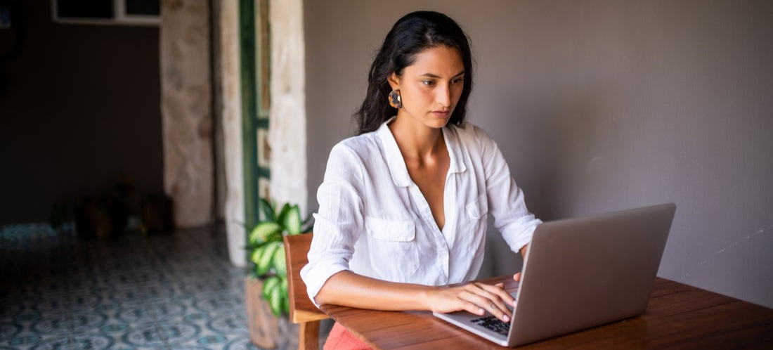 [Featured image] A person uses their laptop to create and use a Mailchimp drip campaign for their online business.