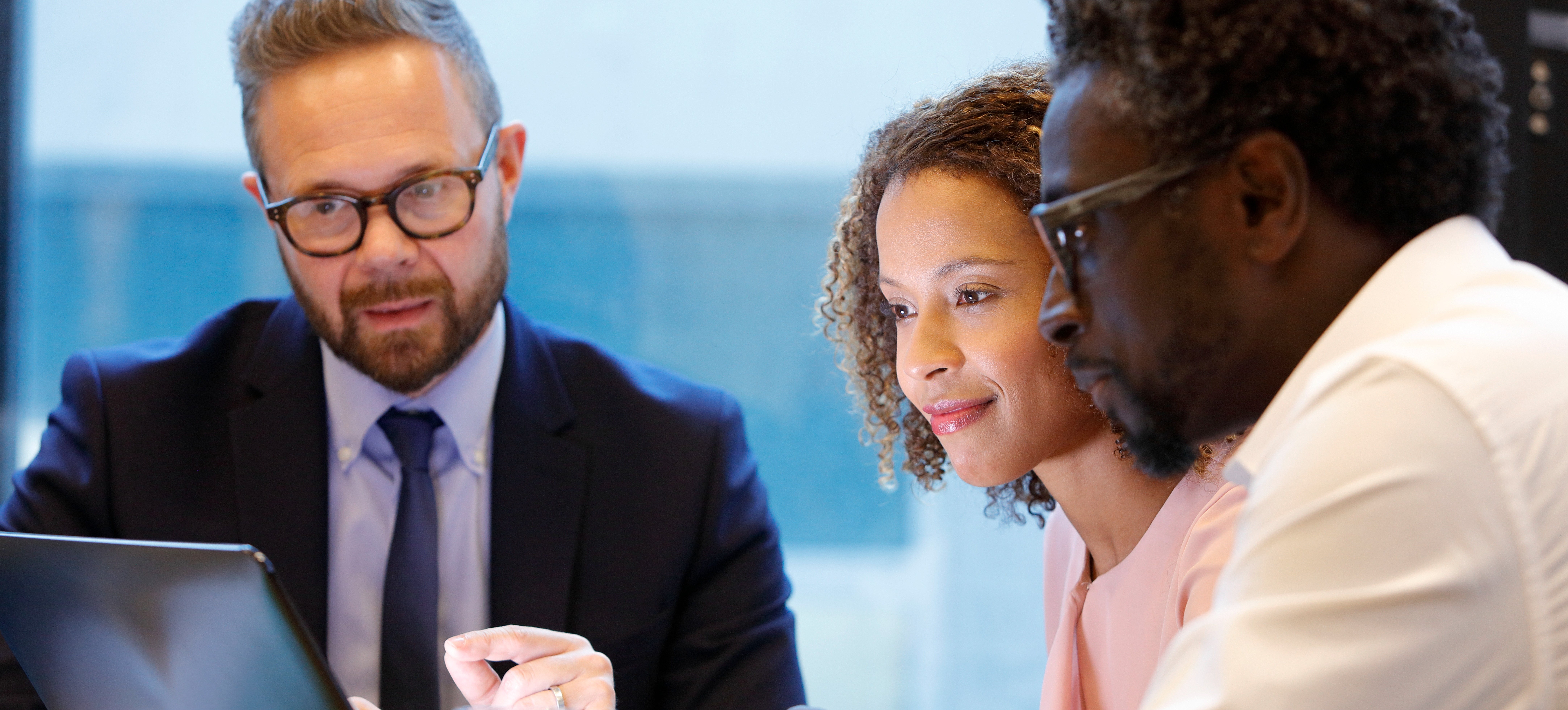 [Featured Image] A financial consultant is meeting with business owners to inform them on their finance analytics report for their business performance.