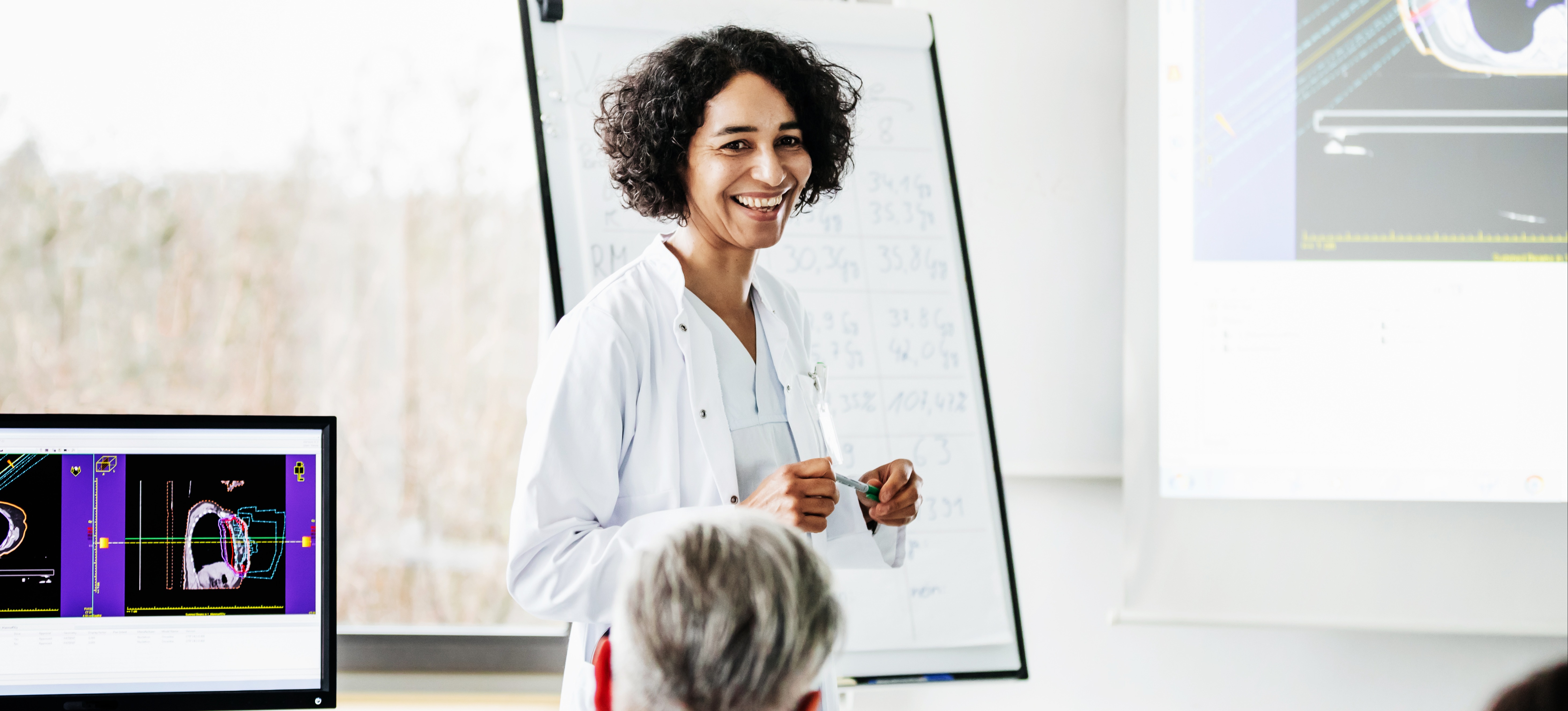 [Featured Image] A medical professional who pursued courses after a BA gives a presentation in front of colleagues.