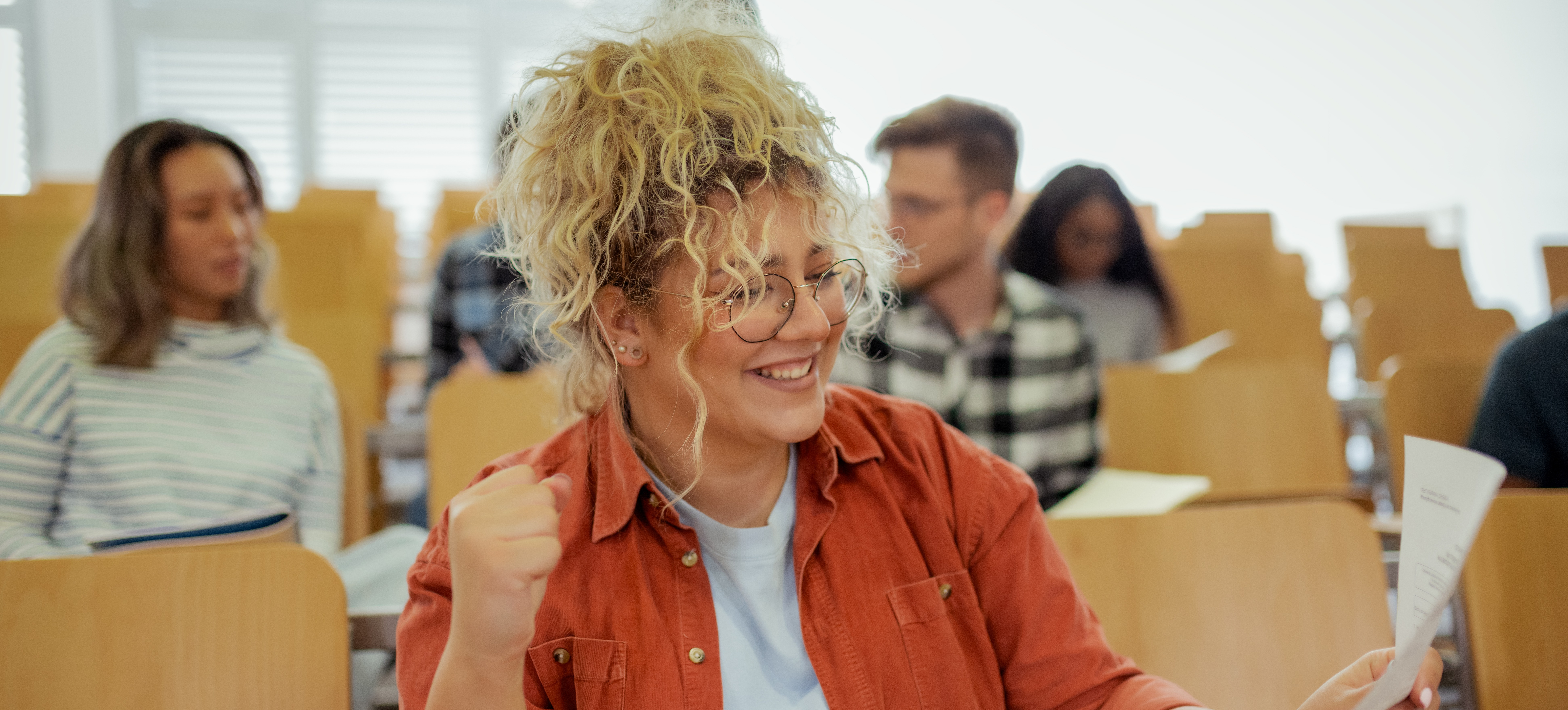 [Featured Image] A person celebrating after receiving their graded certification exam.
