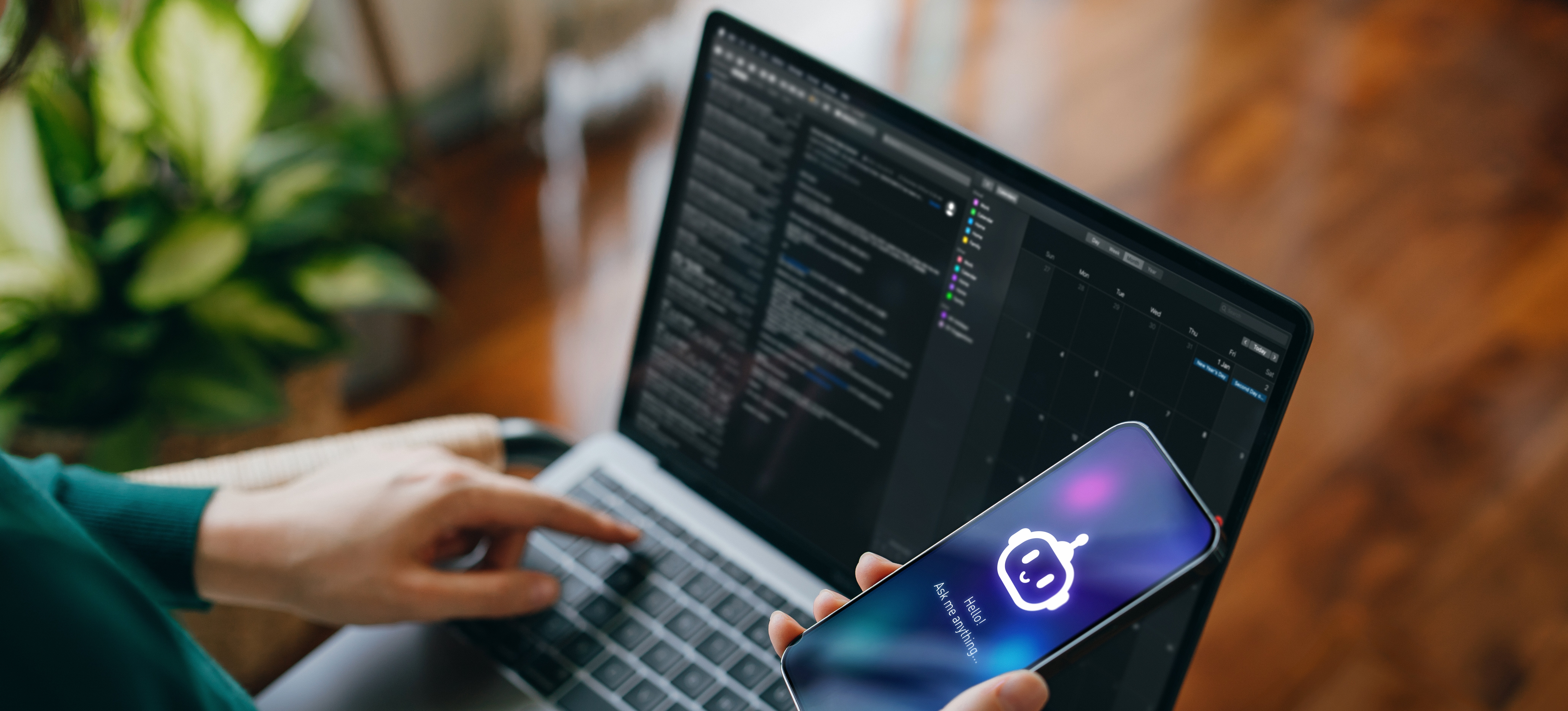 [Featured Image] A person in a green shirt uses a mobile phone and a computer, interacting with two different AI technologies to learn about Microsoft Copilot vs. ChatGPT.
