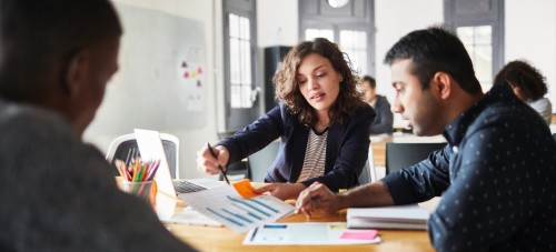 [Featured image] business professionals discussing over a graph