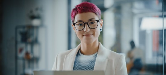 [Featured image] A woman wearing a white jacket is working at her desktop, performing her duties as a data scientist. 