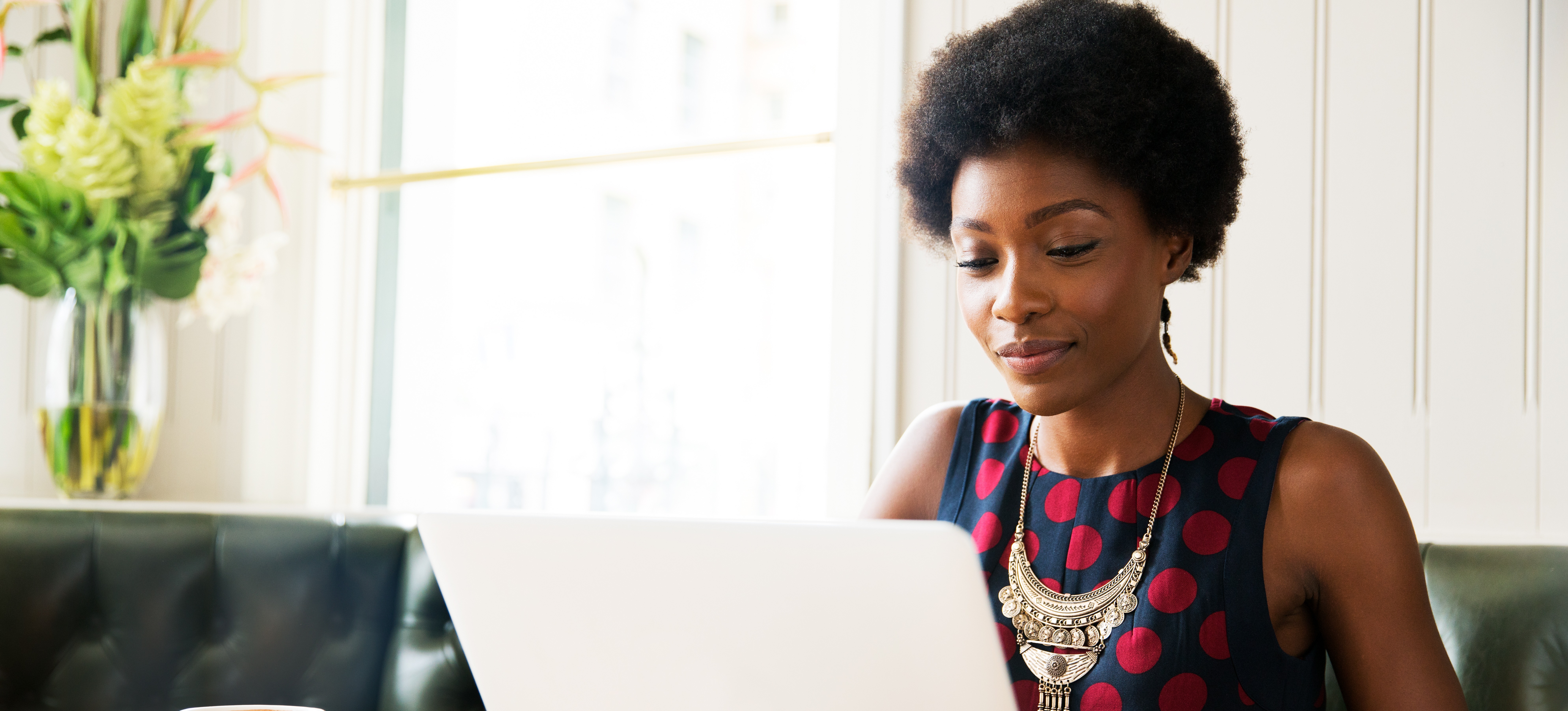 [Feature Image] A college student researches “What is quantum AI” on their laptop while studying for their online degree.
