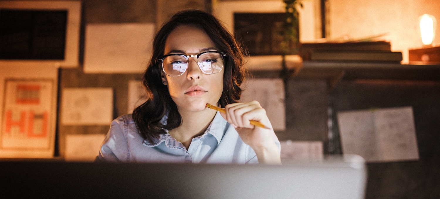 [Featured image] A person working full time and going to school works late in front of a computer screen. The reflection of their laptop can be seen in their glasses. 