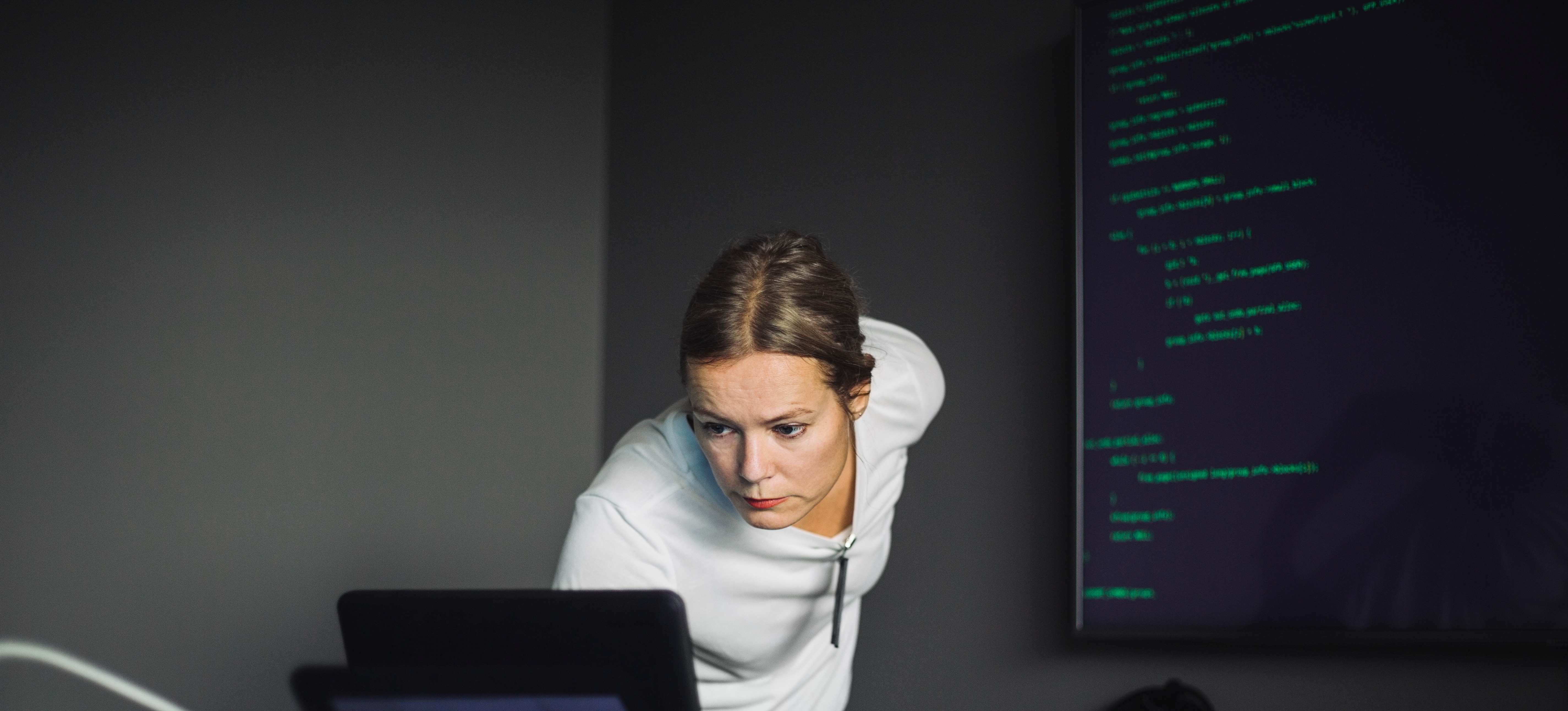 [Featured Image]: A SOC analyst responding to a cyber-related threat on a business computer system.