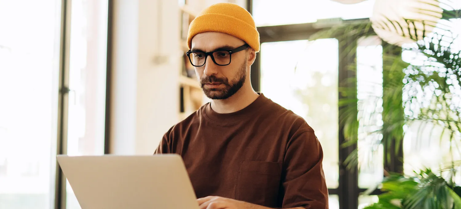 [Featured Image] A web developer works with semi-structured data at their workspace.
