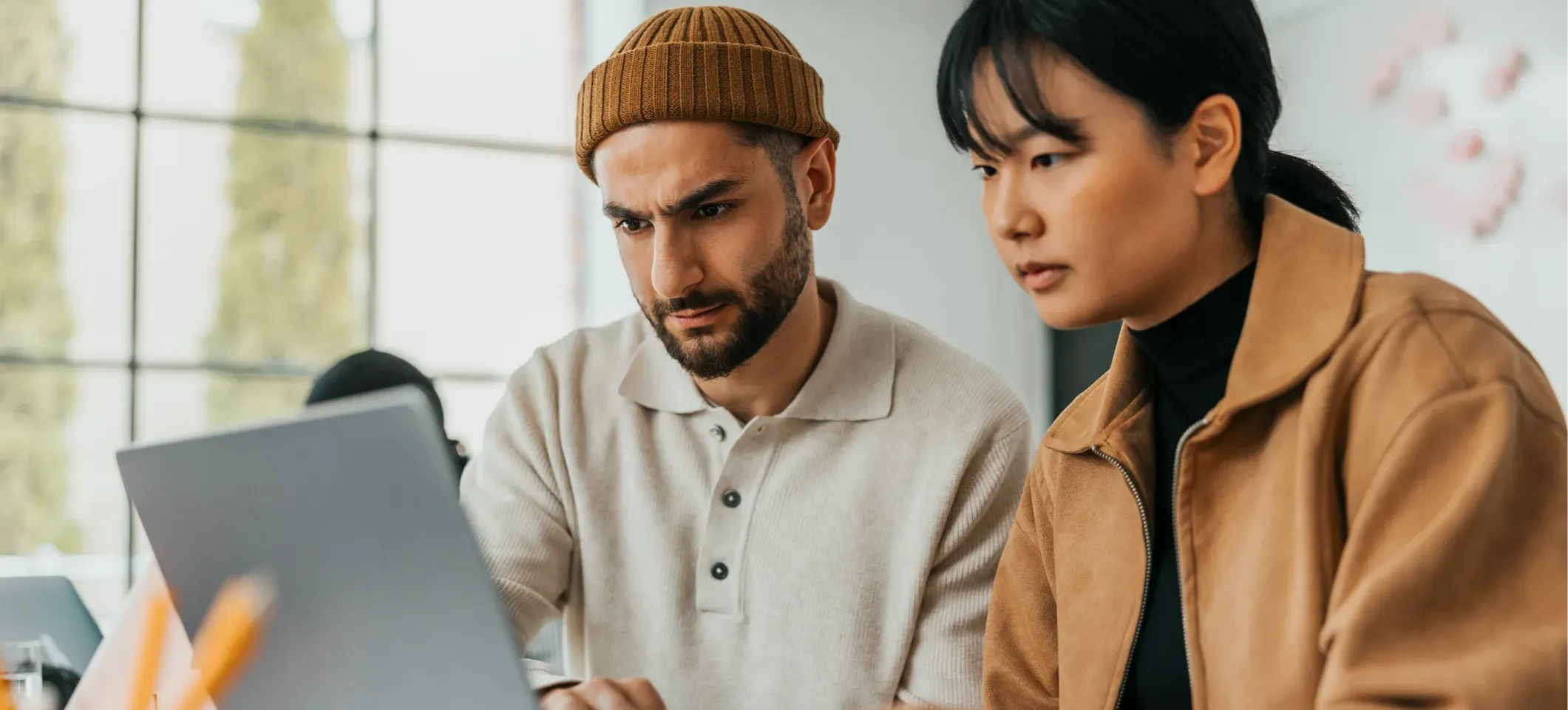 [Featured Image] Two machine learning specialists navigate the curse of dimensionality when working with feature extraction on a computer.
