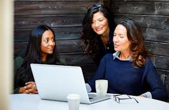 [Featured image] A businesswoman is discussing a proposal on her laptop with her two other colleagues.