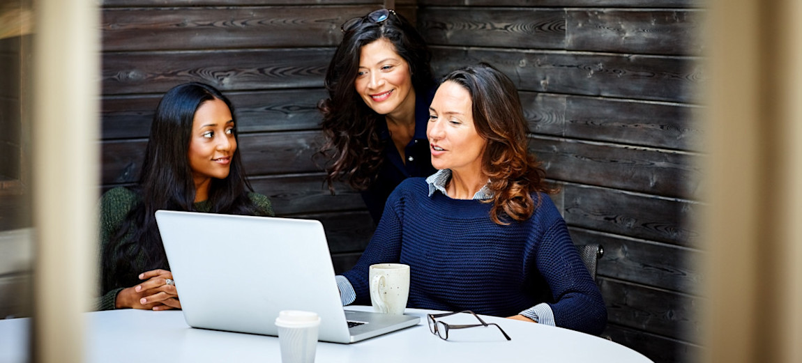 [Featured image] A business person is discussing a proposal on their laptop with their two other colleagues.